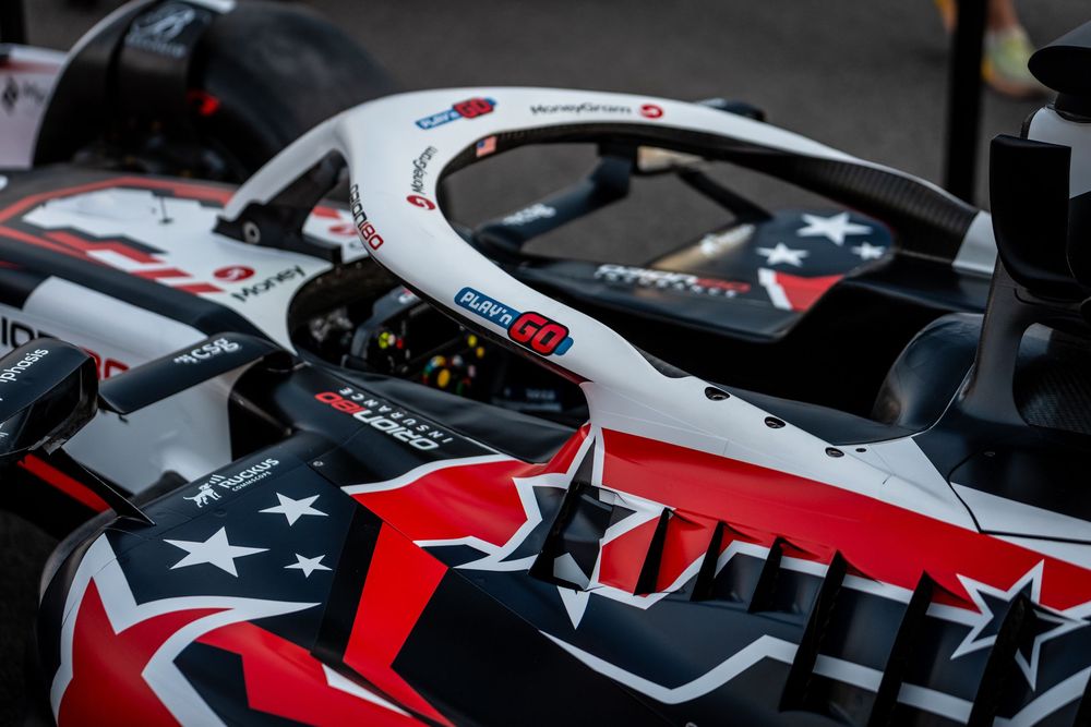 Haas F1 car cockpit detail showing patriotic American stars and stripes livery with number 50 on the headrest.