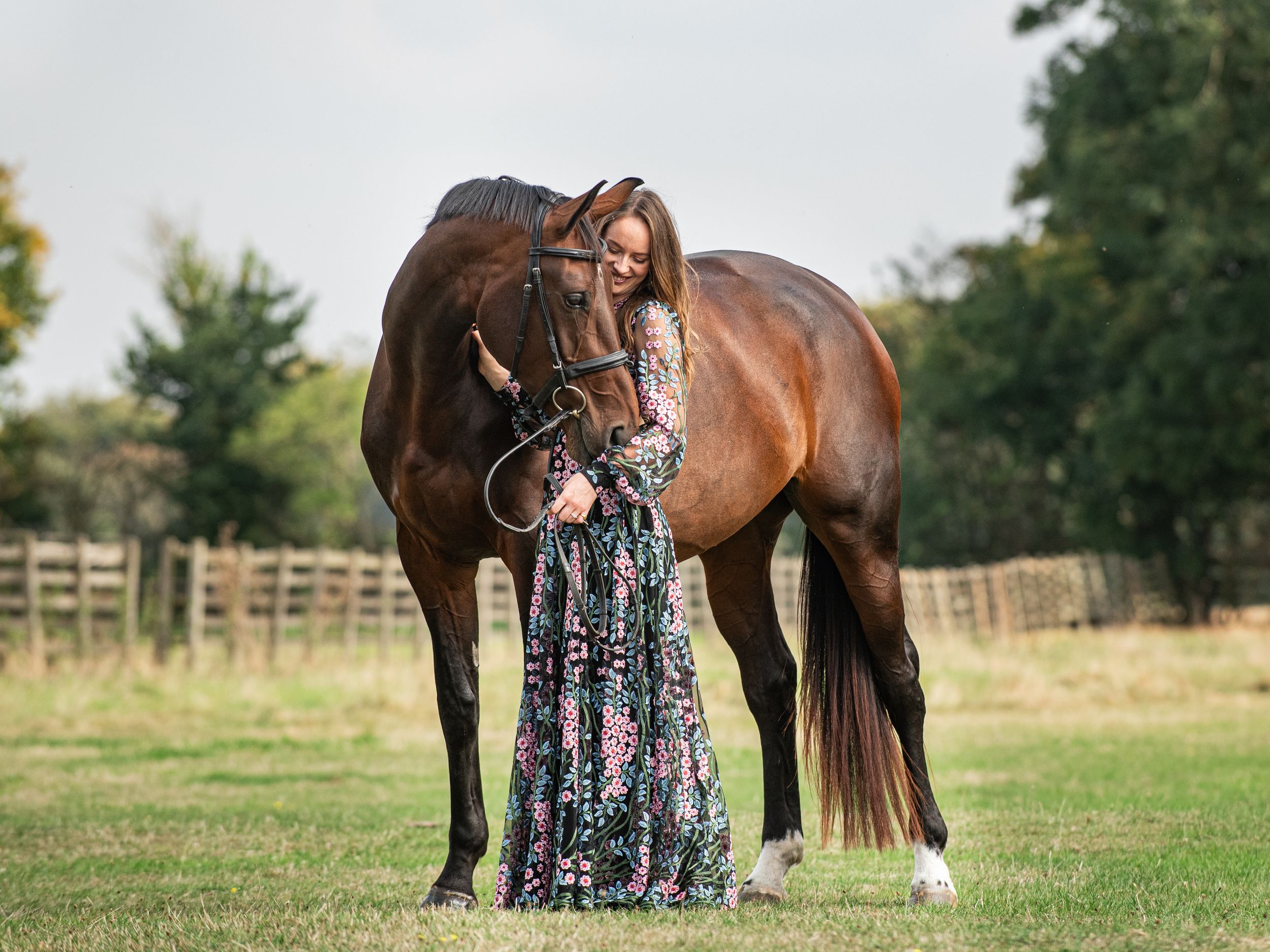 Professional grand prix dressage rider Daisy Coakley during autumnal equine photoshoot wearing beautiful floor length dress gown