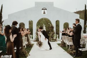 Bride and groom exchanging kiss during sunset ceremony at Jeune Perché luxury wedding venue in Oceanside