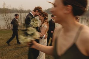 Candid moment at outdoor wedding with motion-blurred bouquet toss.