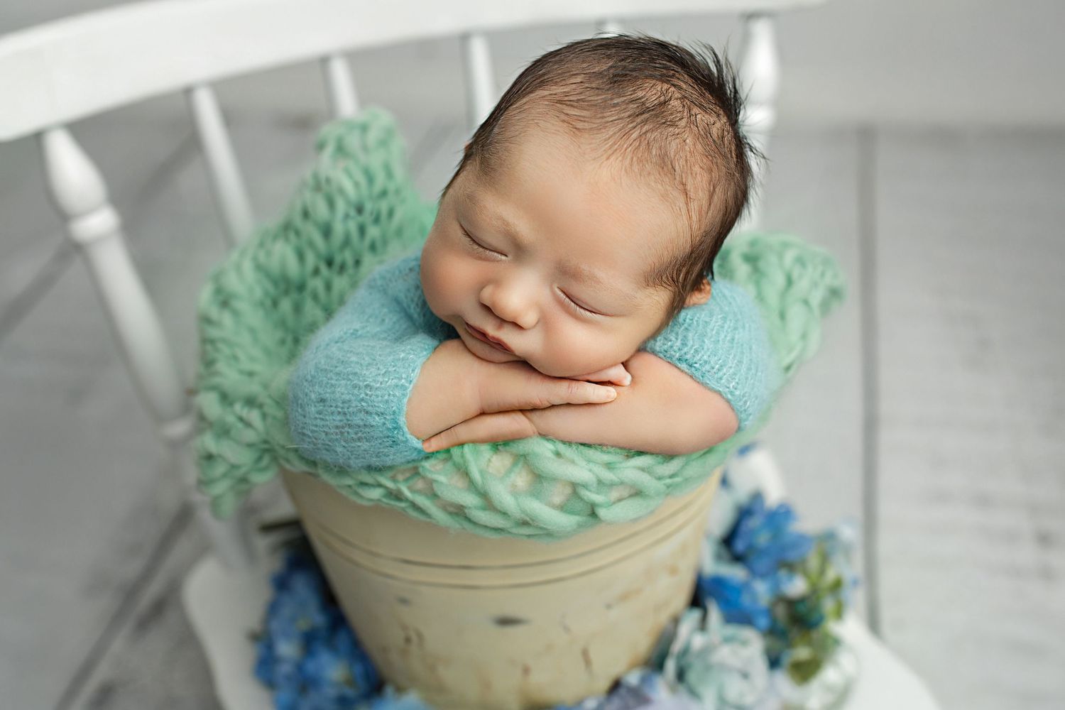 Ipswich newborn photography studio image – baby safely posed on neutral blanket by Buttons & Bows Photography.