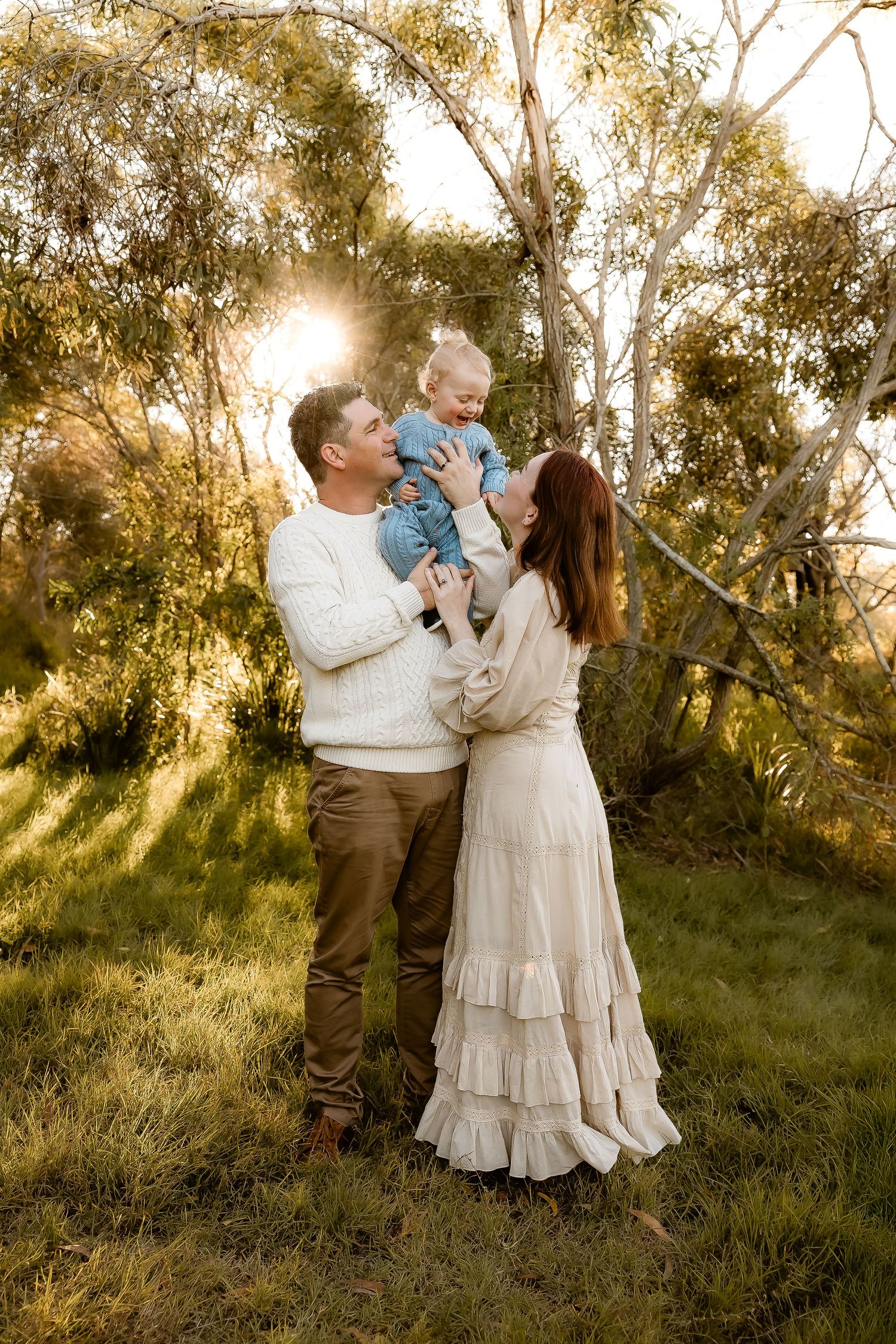 Family laughing and having fun during a family photo shoot in a park in Arana Hills, Brisbane