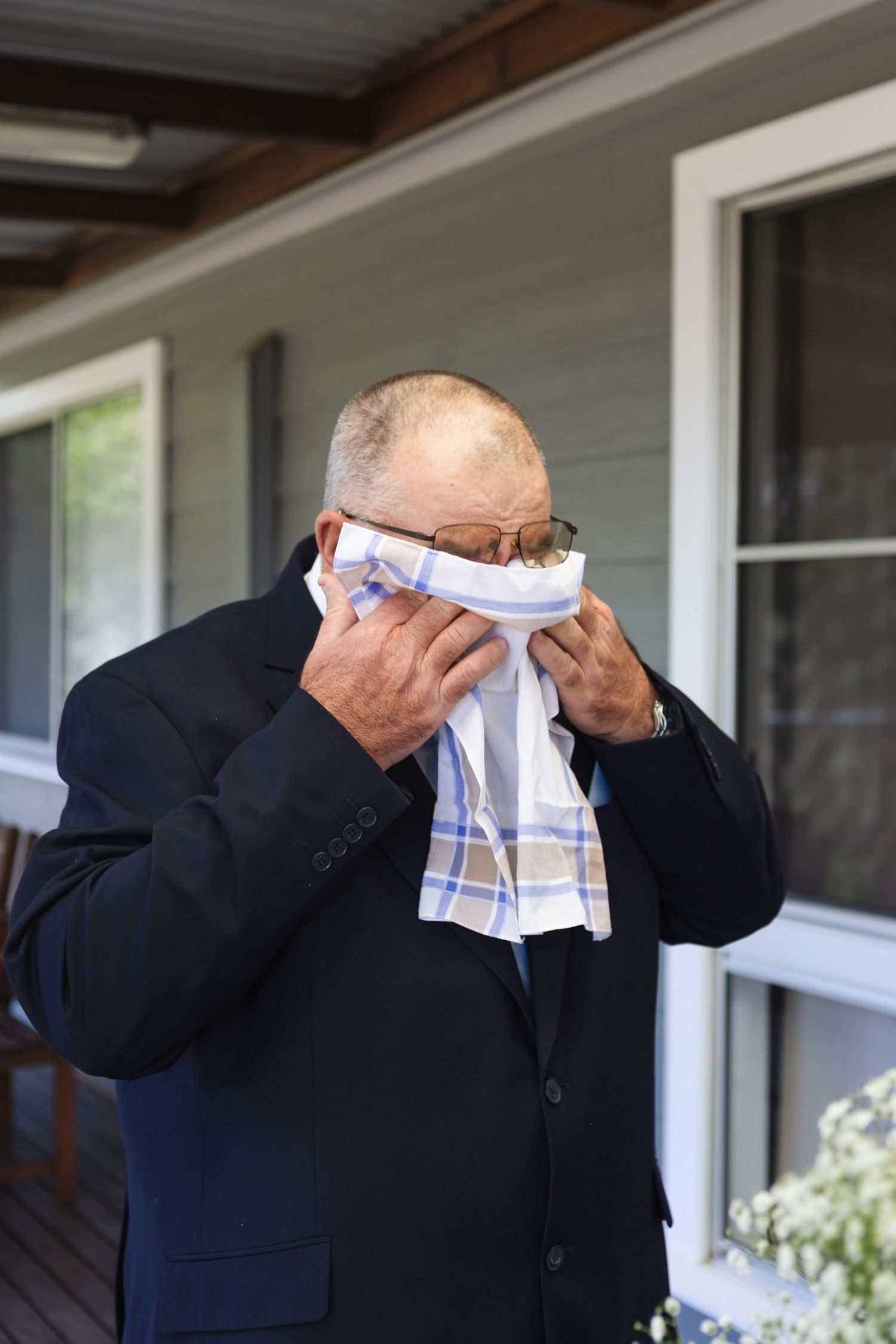 father of the bride crying during first look with his daughter at two rivers winery wedding denman