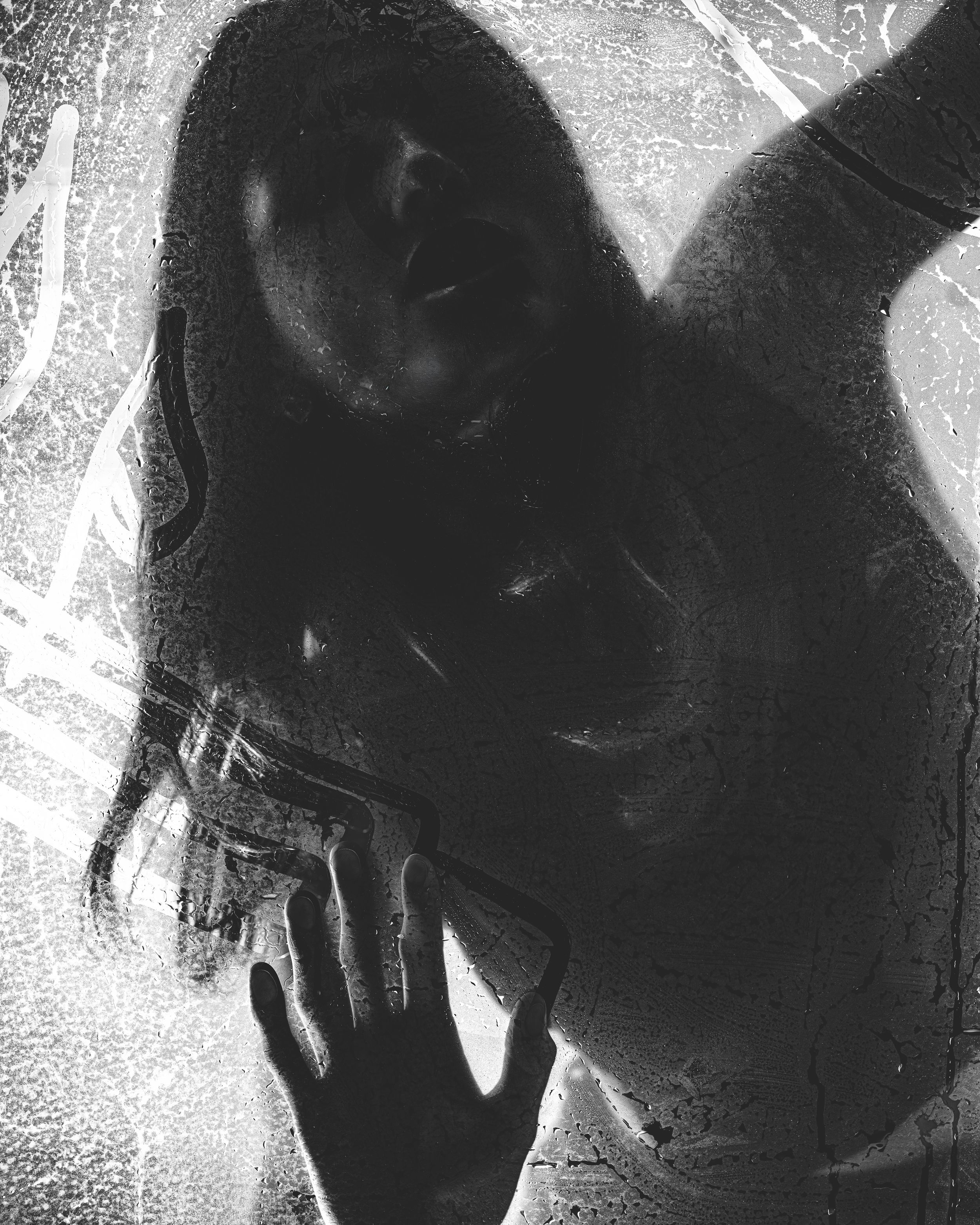 Abstract high-contrast black and white photo of a hand reaching, grainy artistic texture