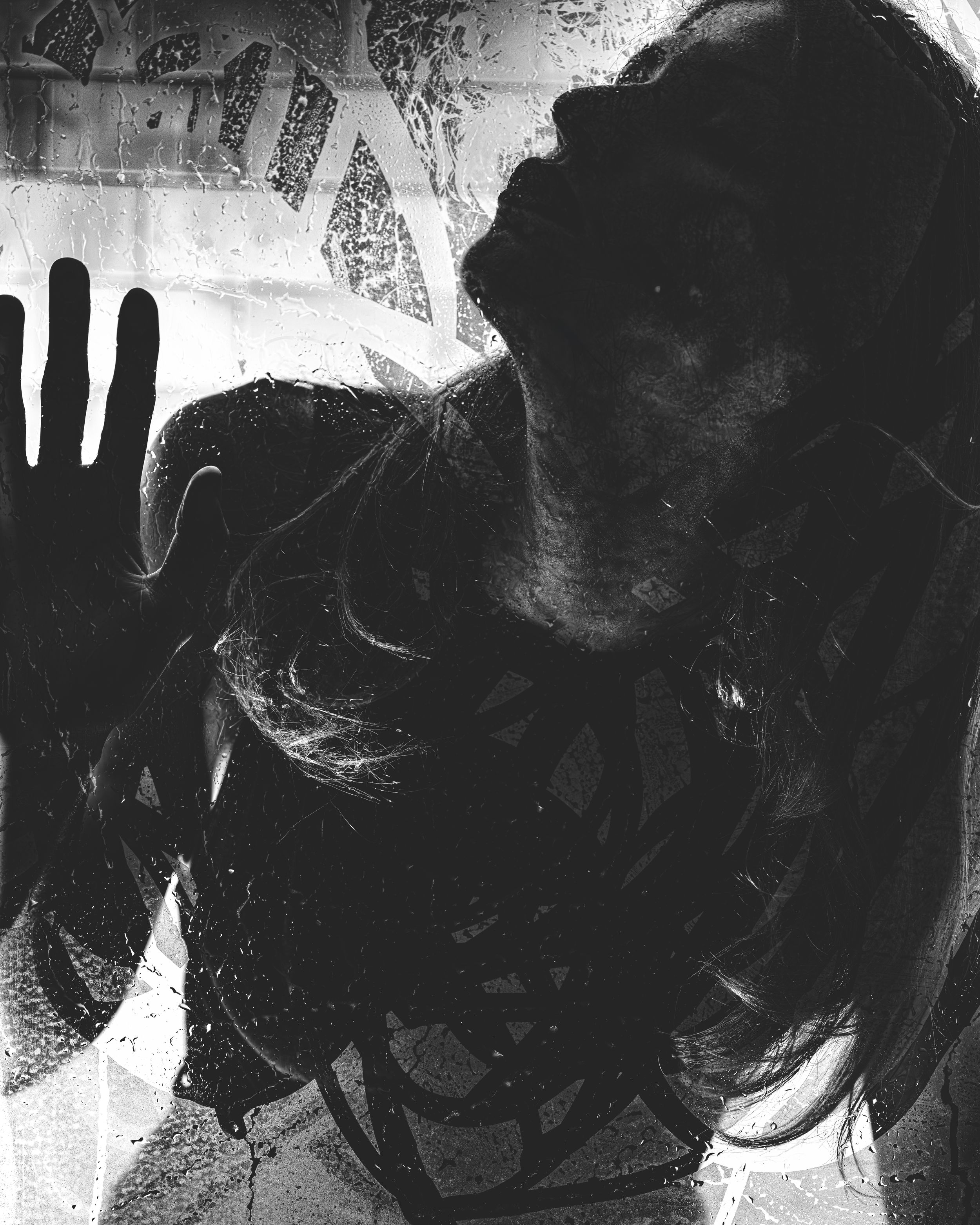 High-contrast black and white silhouette portrait of a woman with curly hair, hand raised, dramatic shadows