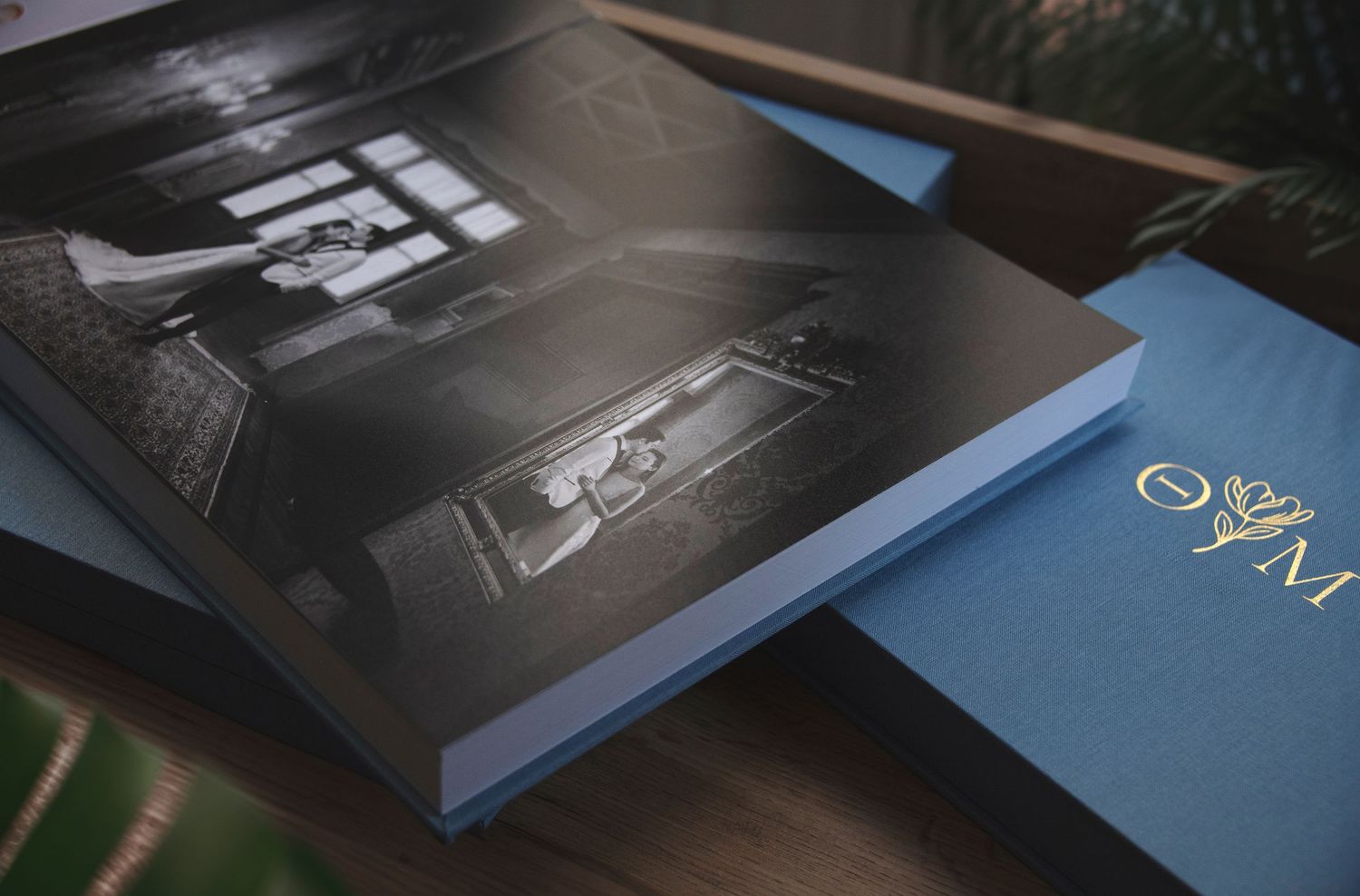 Luxury fine art wedding album with custom gold foil embossing and high-quality black and white photo prints.