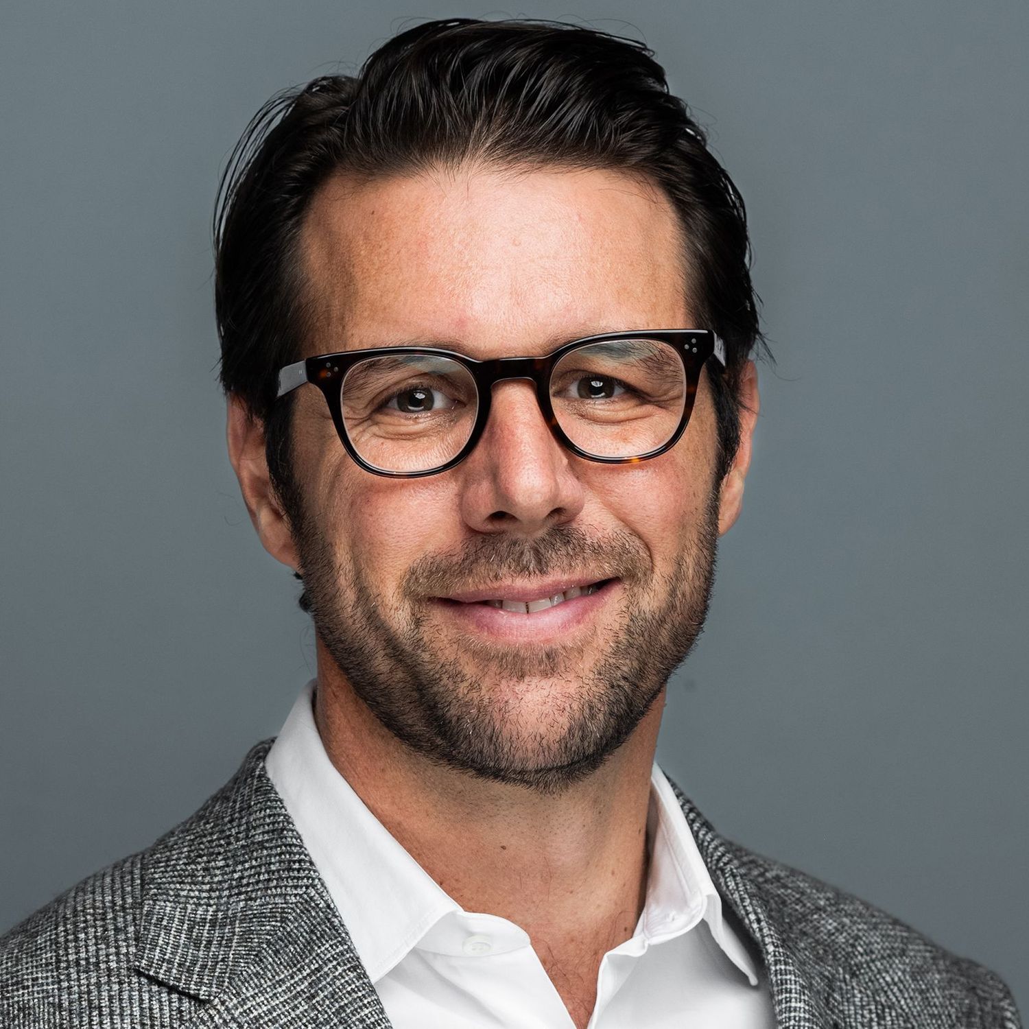 Orlando headshot photographer — clean studio headshot of professional man with glasses and blazer