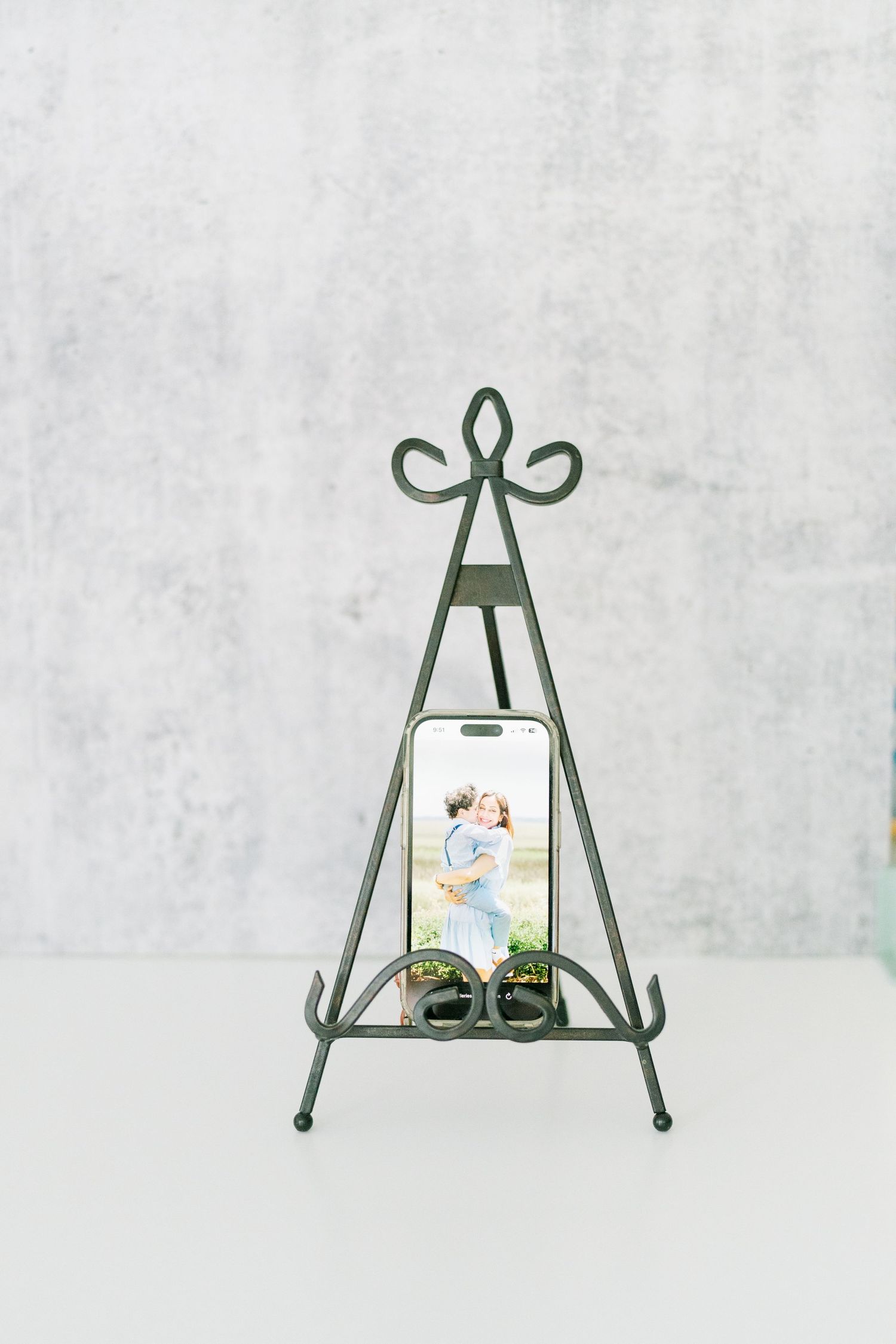Photo of a cell phone on an easel. Enjoy your family portraits in real life, not just your phone