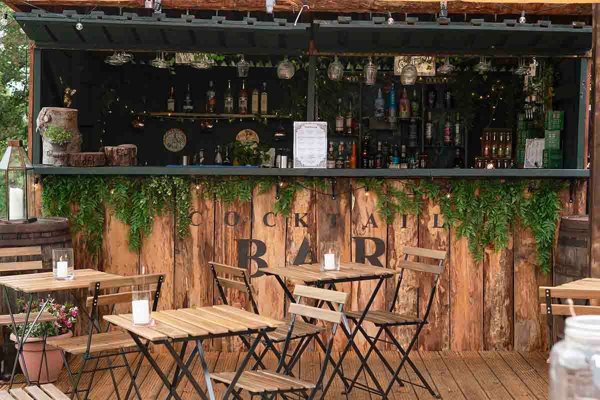 the outdoor cocktail bar at the den at four acre - a magnificent unique wedding venue near wigton.