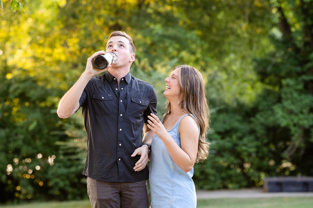 Newly engaged couple celebrating with champagne after a surprise proposal in Mountain Home, Arkansas