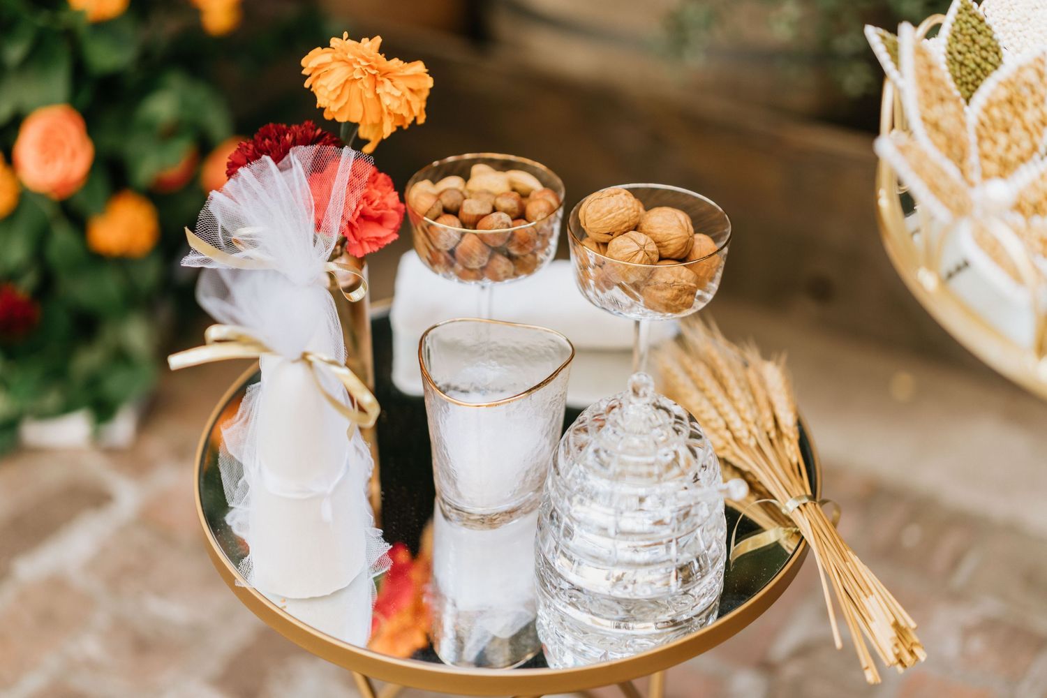Wedding ceremony table featuring ceremonial items, candles, and traditional accessories.