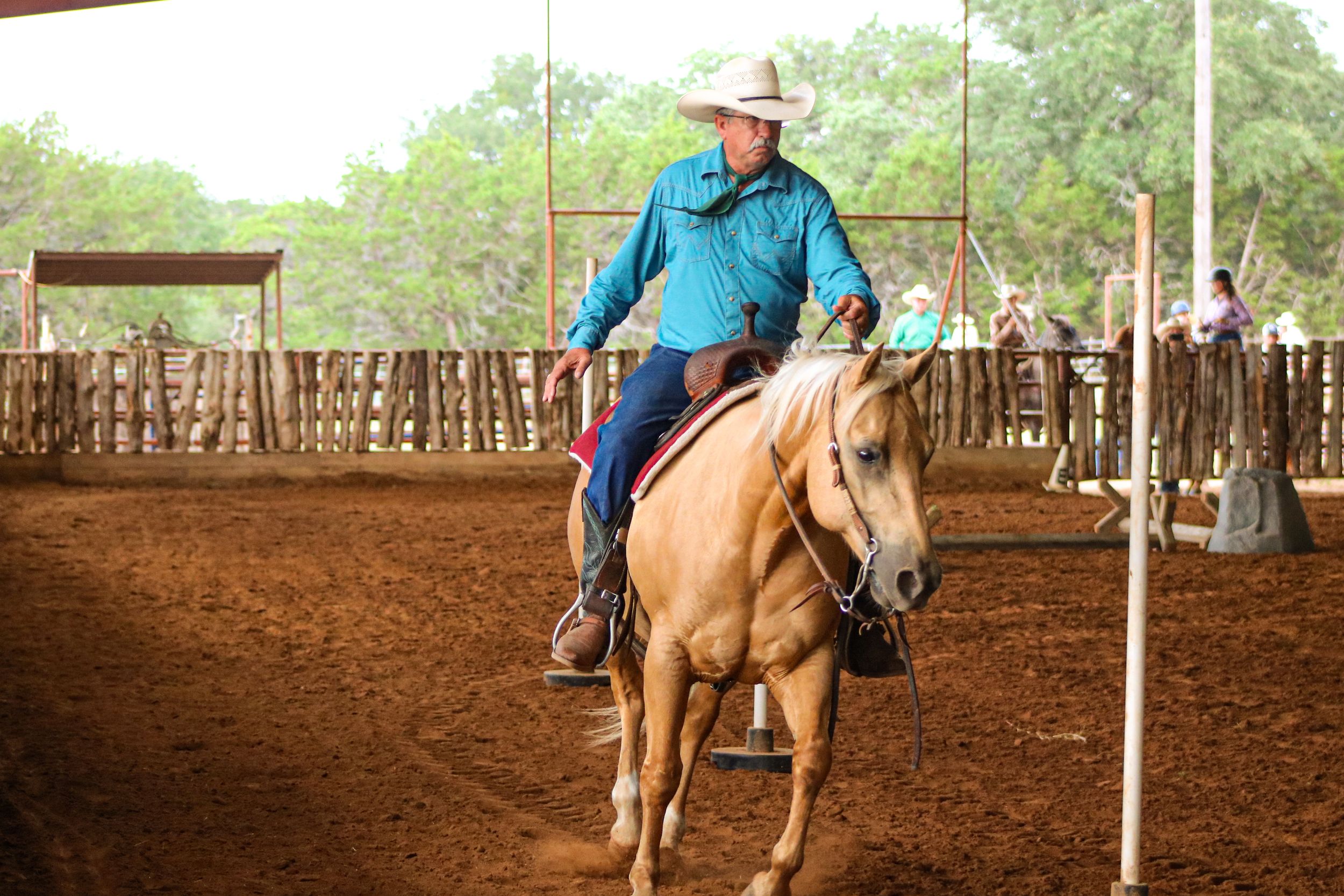 A man rides a western pony in a horse show