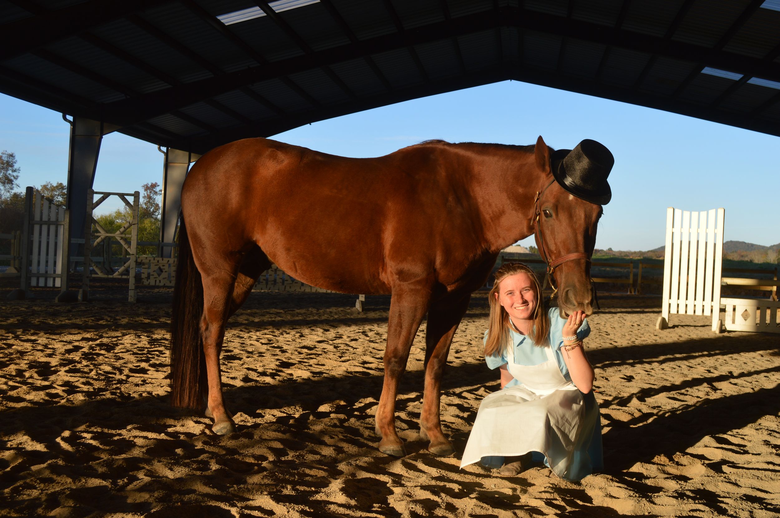 Girl and horse pose as Alice and The Mad Hatter