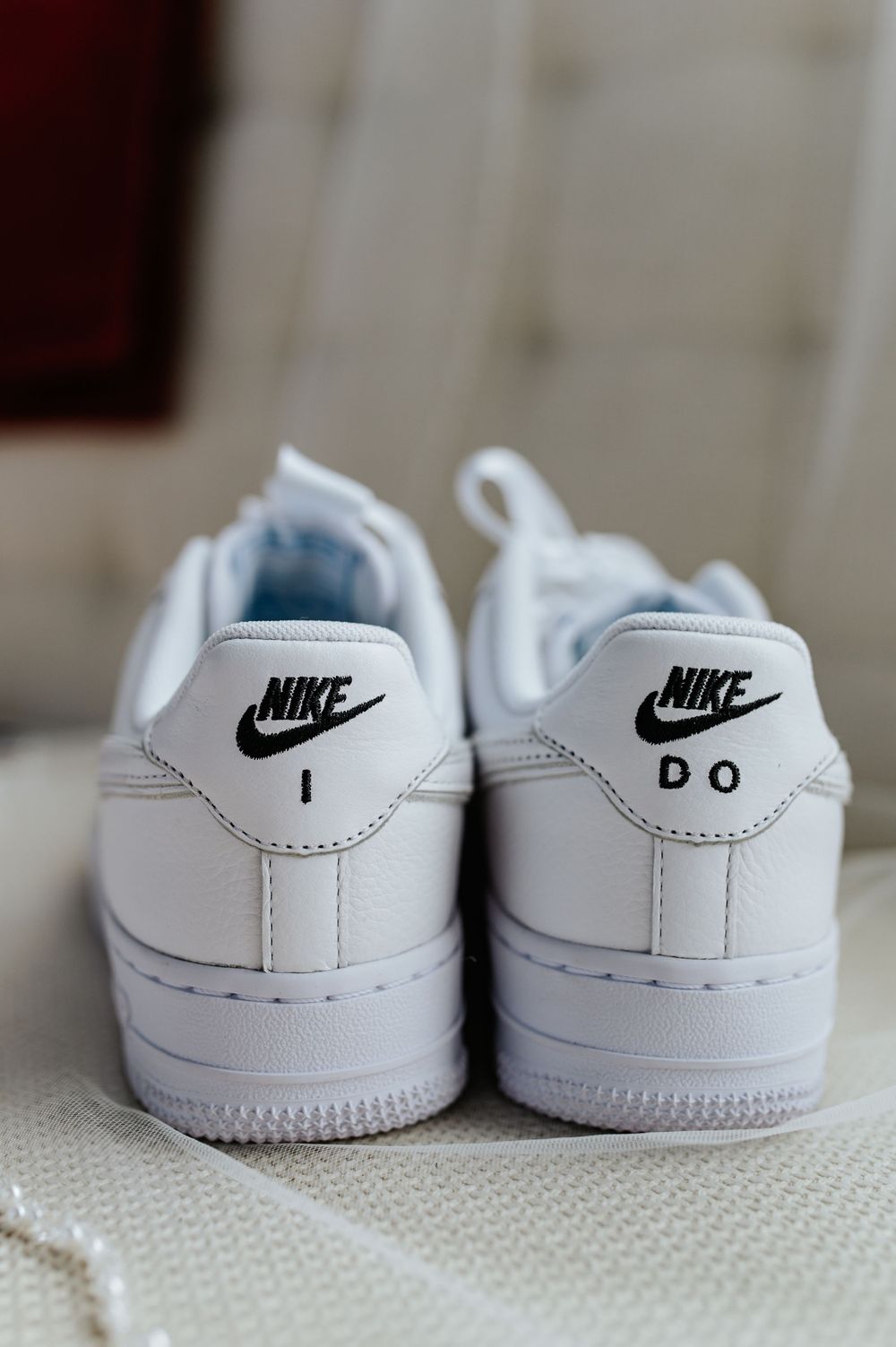 Custom Nike Air Force 1 wedding sneakers with I DO printed on the heels in black text.