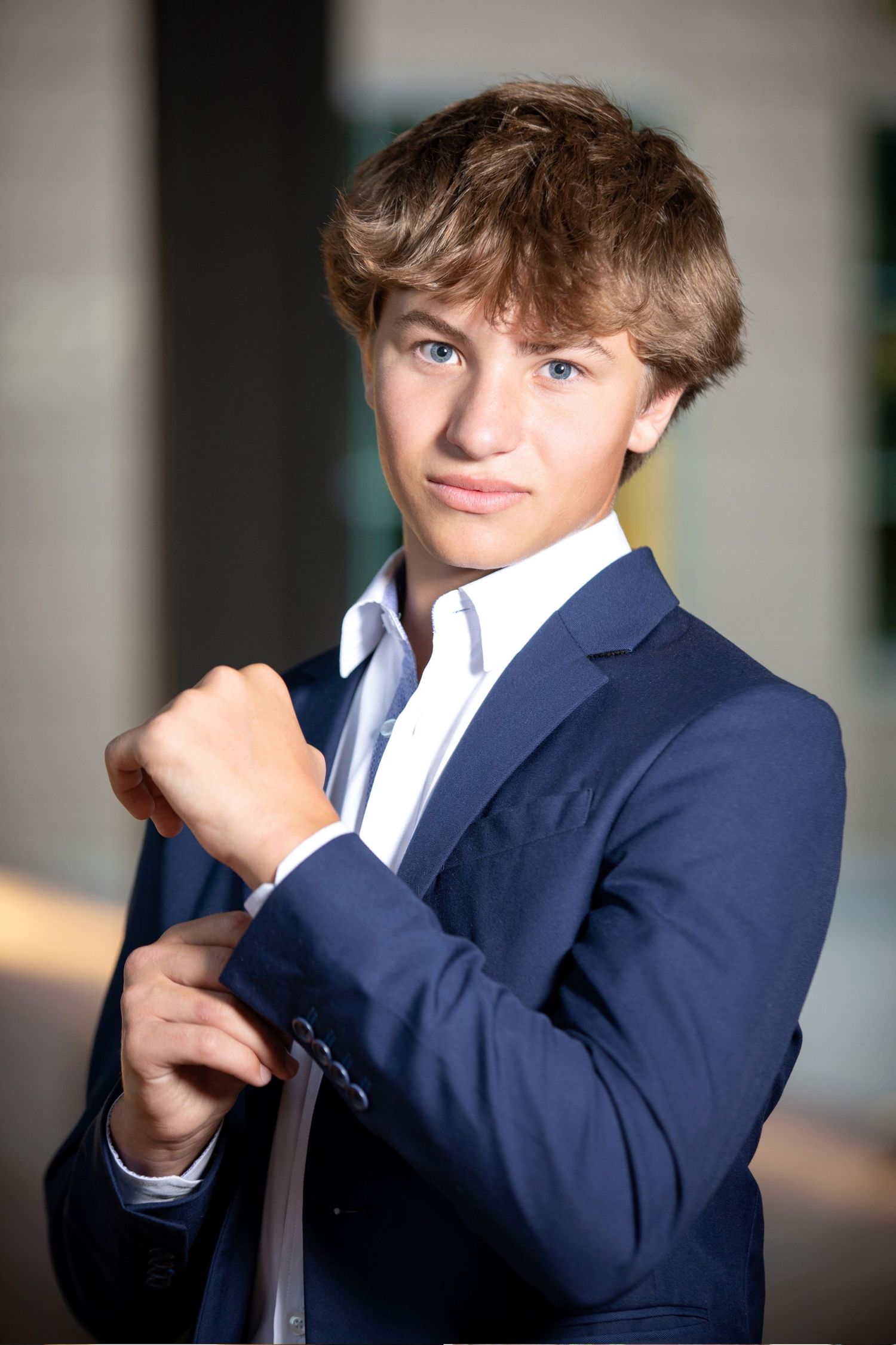 Olentangy senior portrait in a navy suit taken in the Arena District Columbus Ohio with a polished modern look.