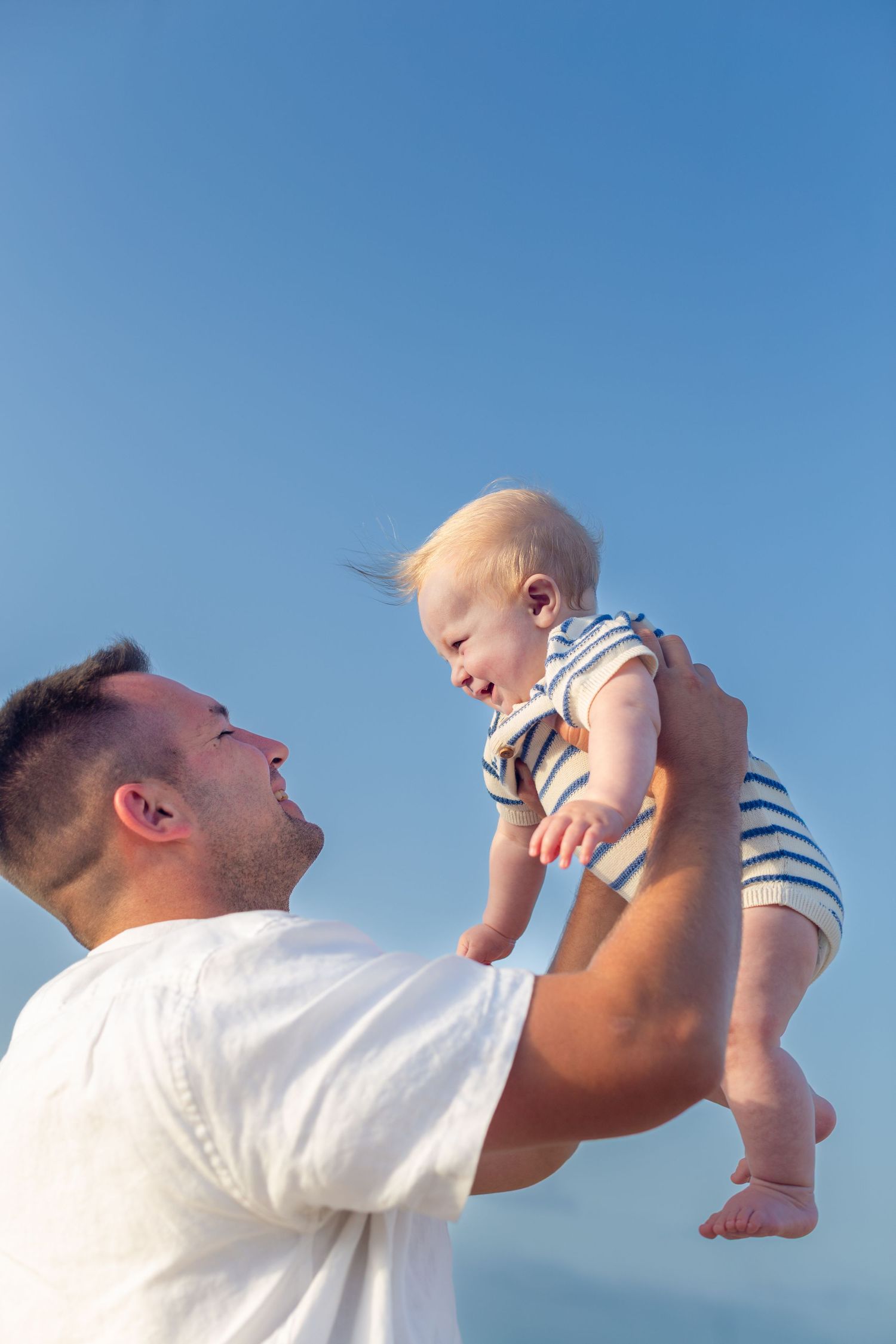 Portrait of father and baby boy on the beach in Isla Verde, Carolina, Puerto Rico.