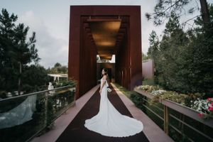 Wedding photos captured in a rustic wooden covered bridge with dramatic lighting.