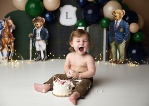Toddler enjoying cake during a styled birthday cake smash photography session.