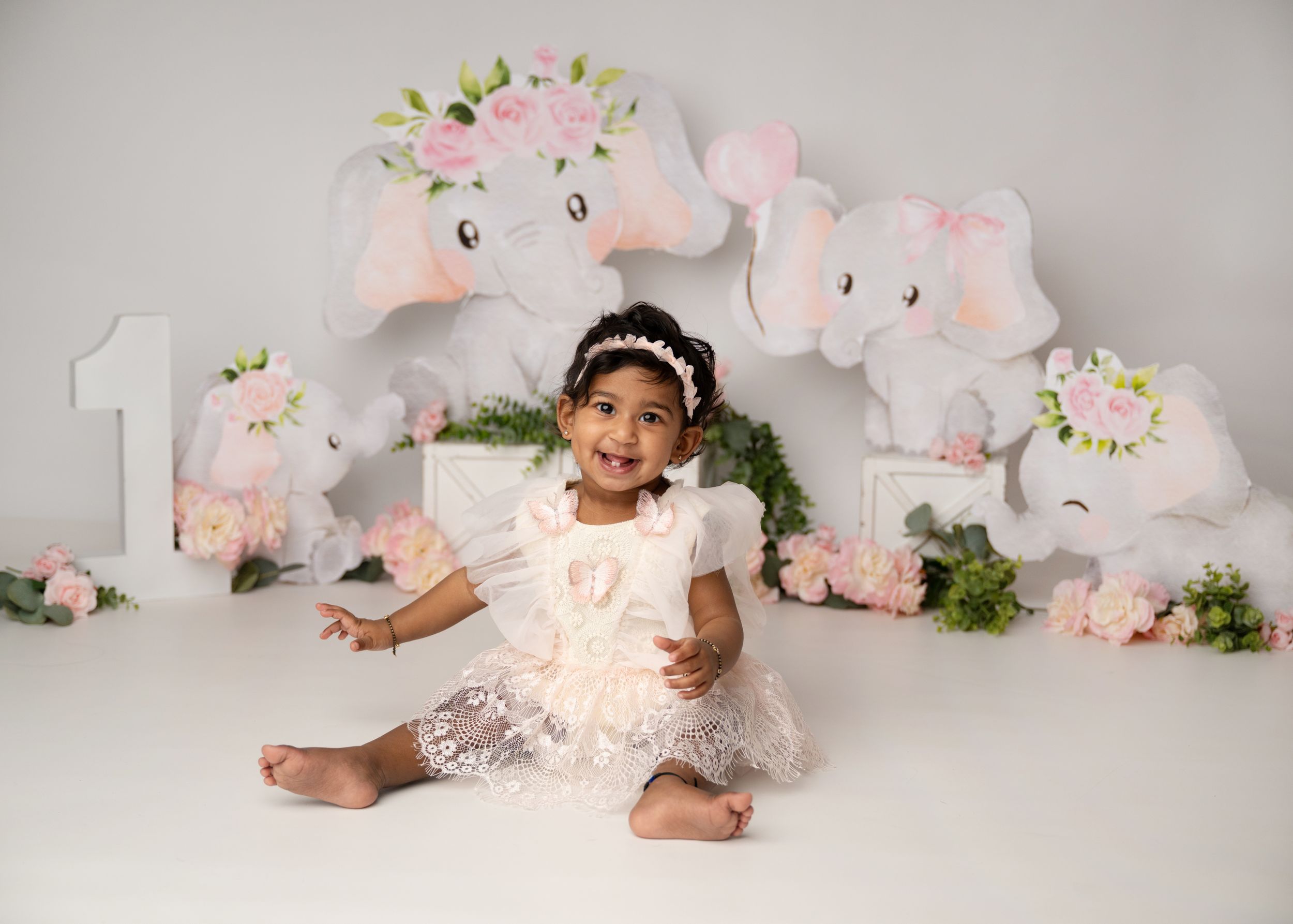 Child posing in a pastel birthday setup during a cake smash session in New Jersey.