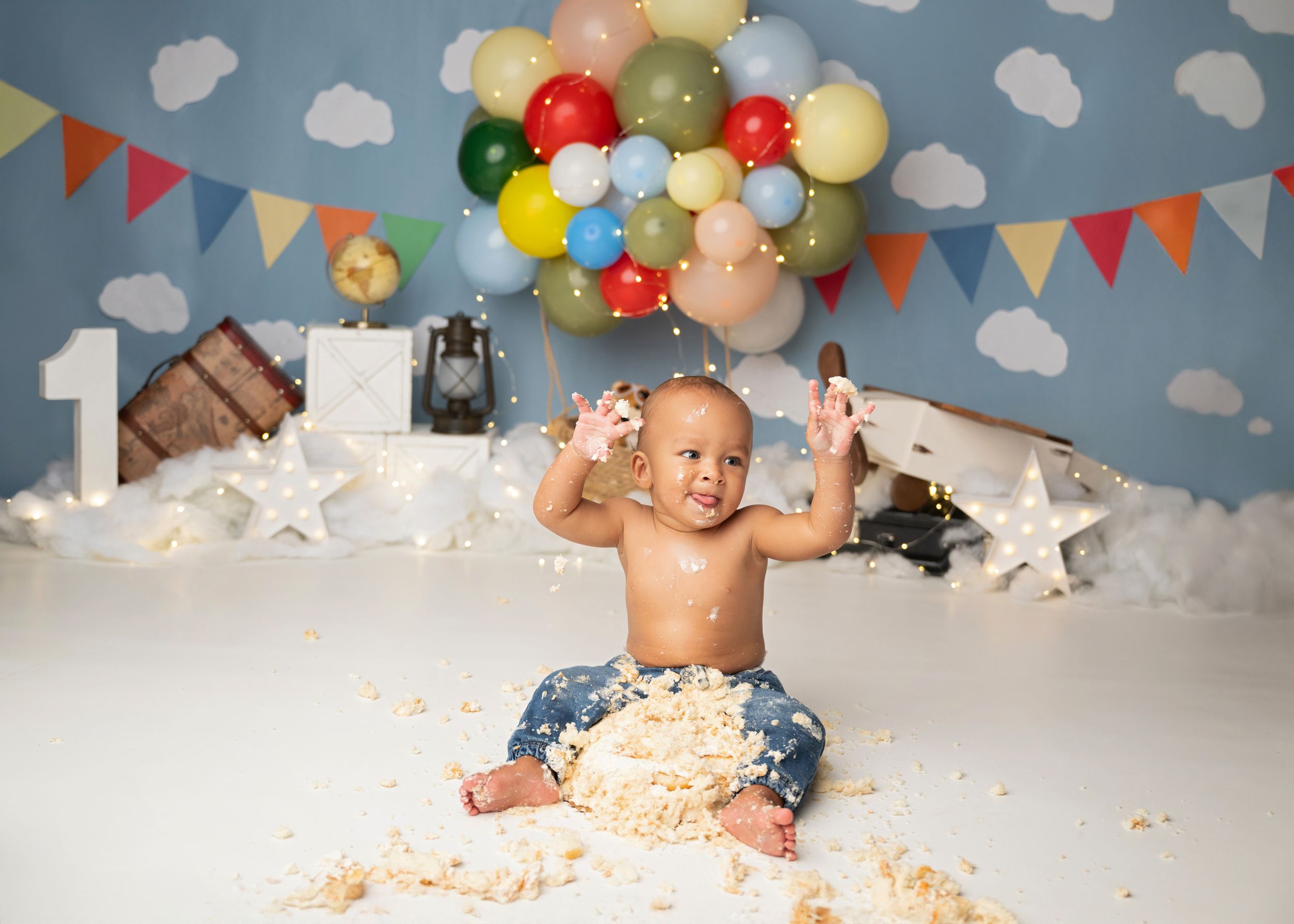 Baby celebrating a birthday during a custom cake smash photography session in New Jersey.
