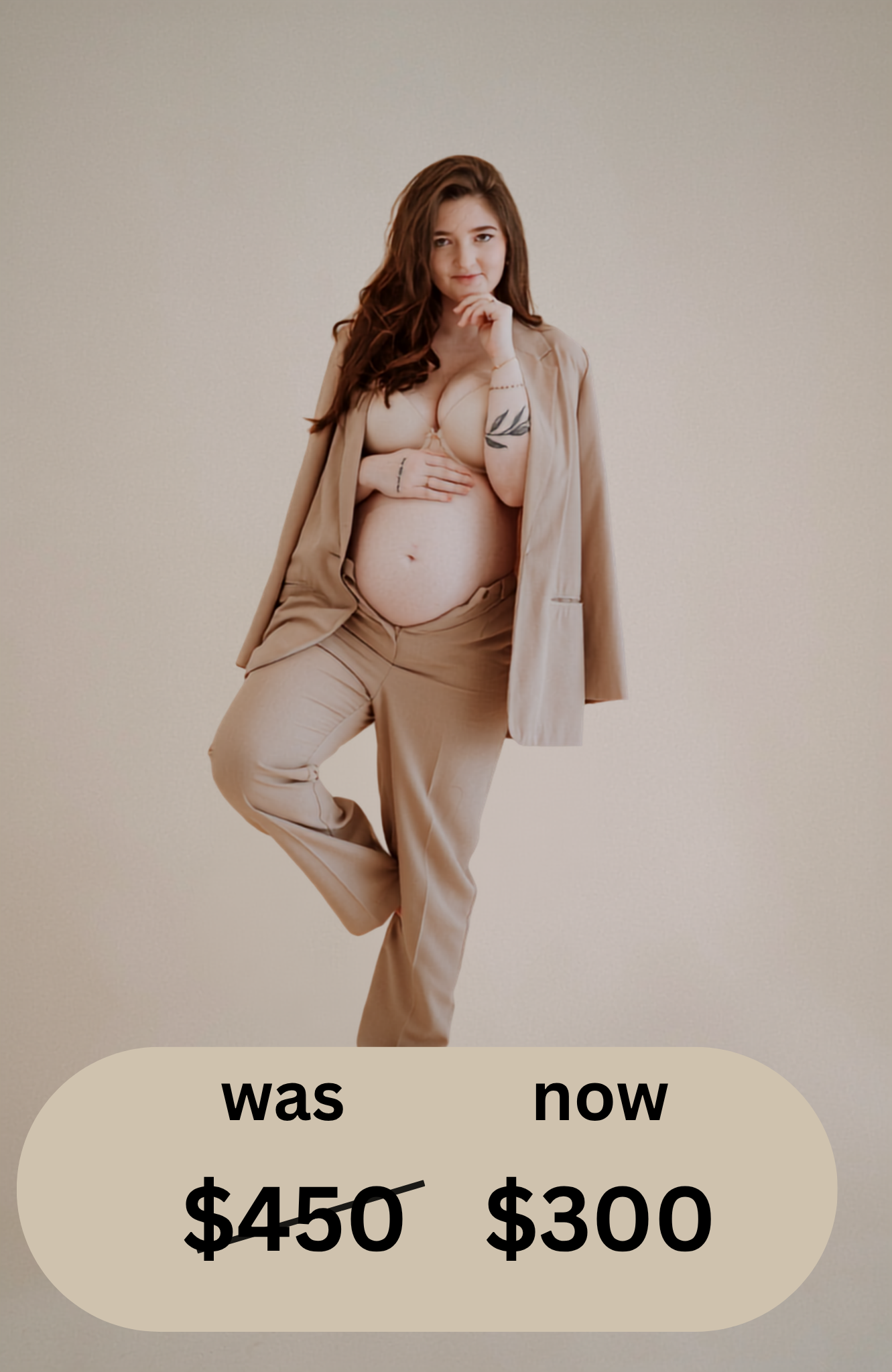 Pregnant woman in beige blazer and matching pants poses gracefully in a studio maternity photoshoot.