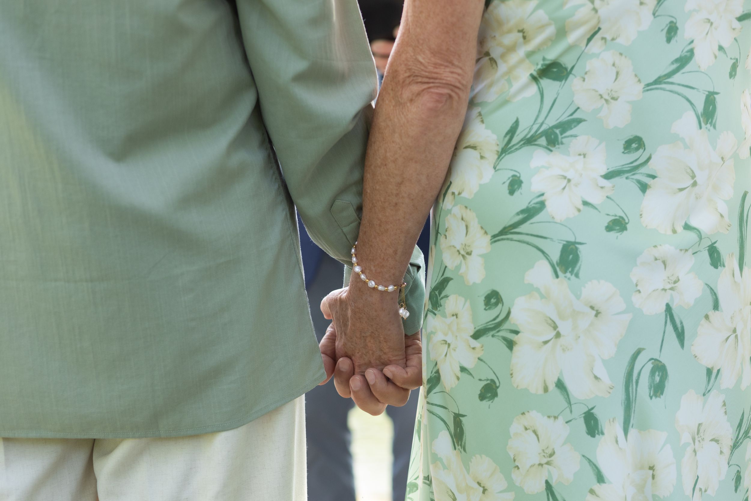 Karen and George holding hands at the end of their wedding day