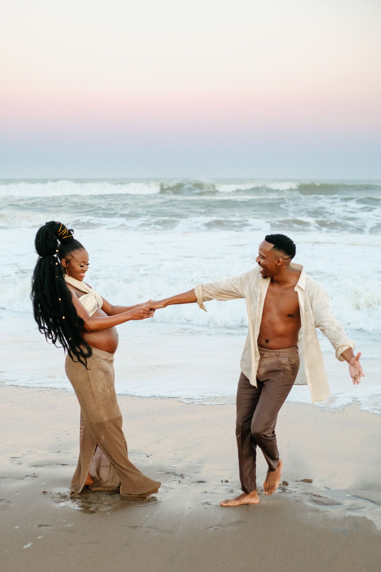 Parents to be dancing in the waves