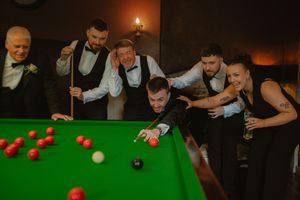 Group of friends laughing and enjoying a game of snooker at a pool table at Boyne Hill House Estate