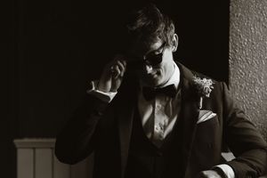 Groom in black tuxedo and bow tie at Boyne Hill House, in a dramatic black and white wedding portrait.