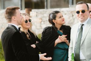 Group of elegantly dressed guests socializing outdoors at a formal event, wearing sunglasses and smart attire at Boyne Hill House Estate