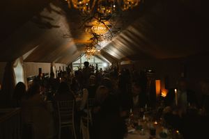 Elegant wedding reception with chandelier lighting and guests celebrating at Boyne Hill House Estate.