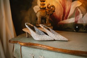 Elegant crystal-embellished slingback heels displayed on a vintage dresser with a decorative at Boyne Hill House Estate, Co. Meath