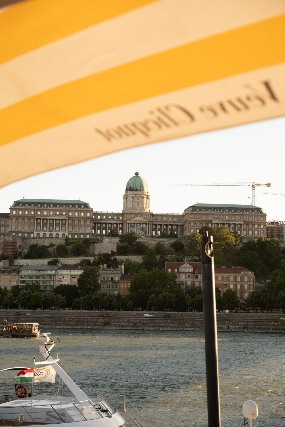 Buda Castle seen across the Danube from under a cafe awning, Budapest