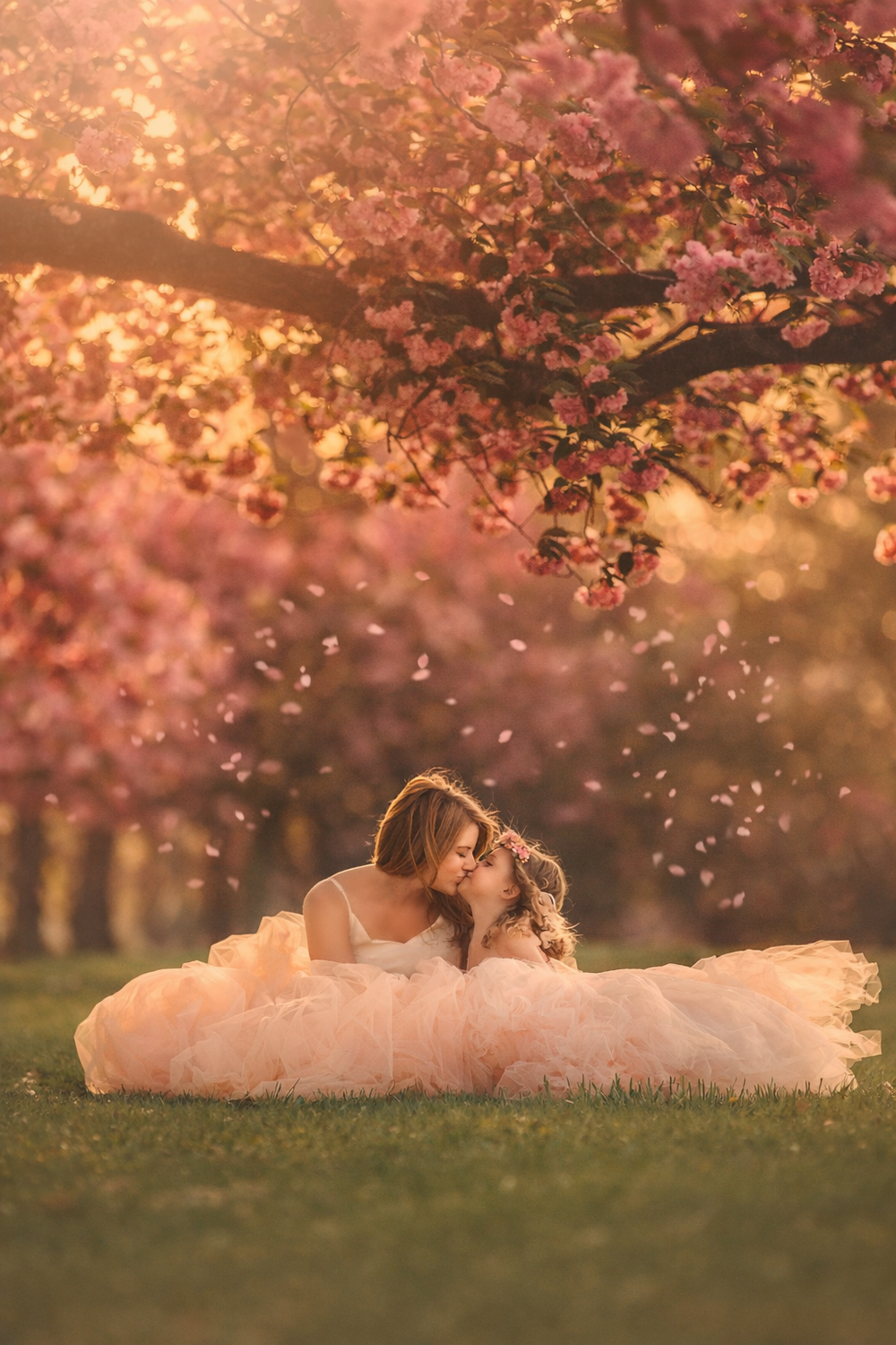 Mom and daughter together beneath pink cherry blossoms during a spring family photography session in South Jersey.