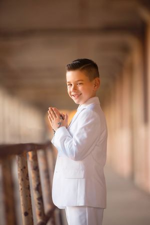 Young boy posing for his First Holy Communion portrait session.
