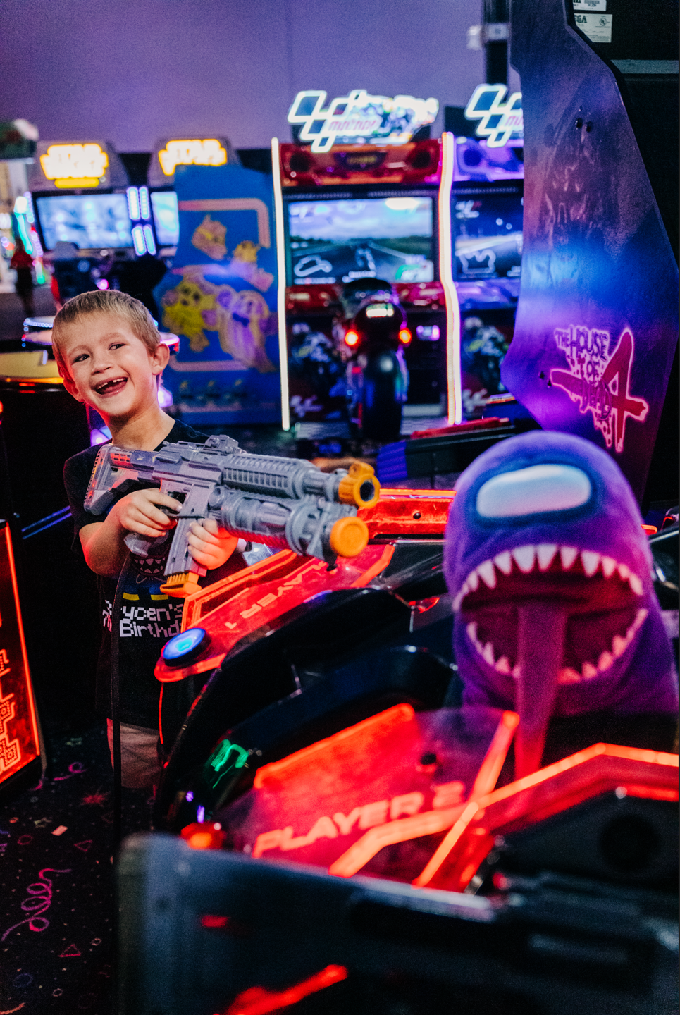 Colorful arcade birthday photos in Lake Worth Beach of a boy playing games at Fun Depot.
