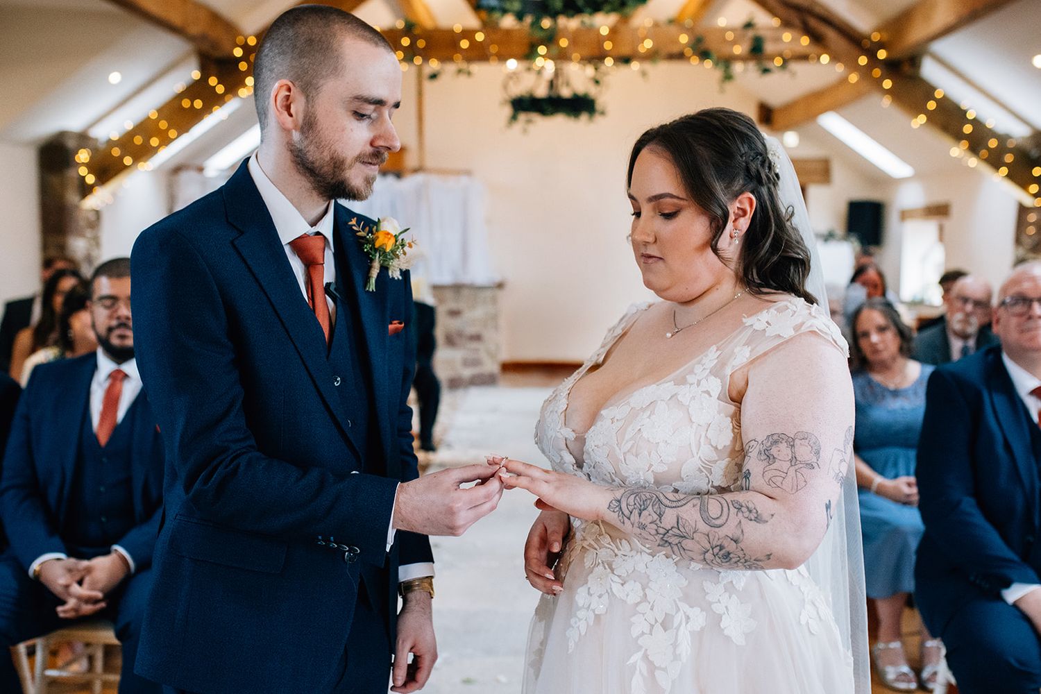 couple under the oak beams at Beeston Manor in Lancashire, where the ring is being placed on the brides finger