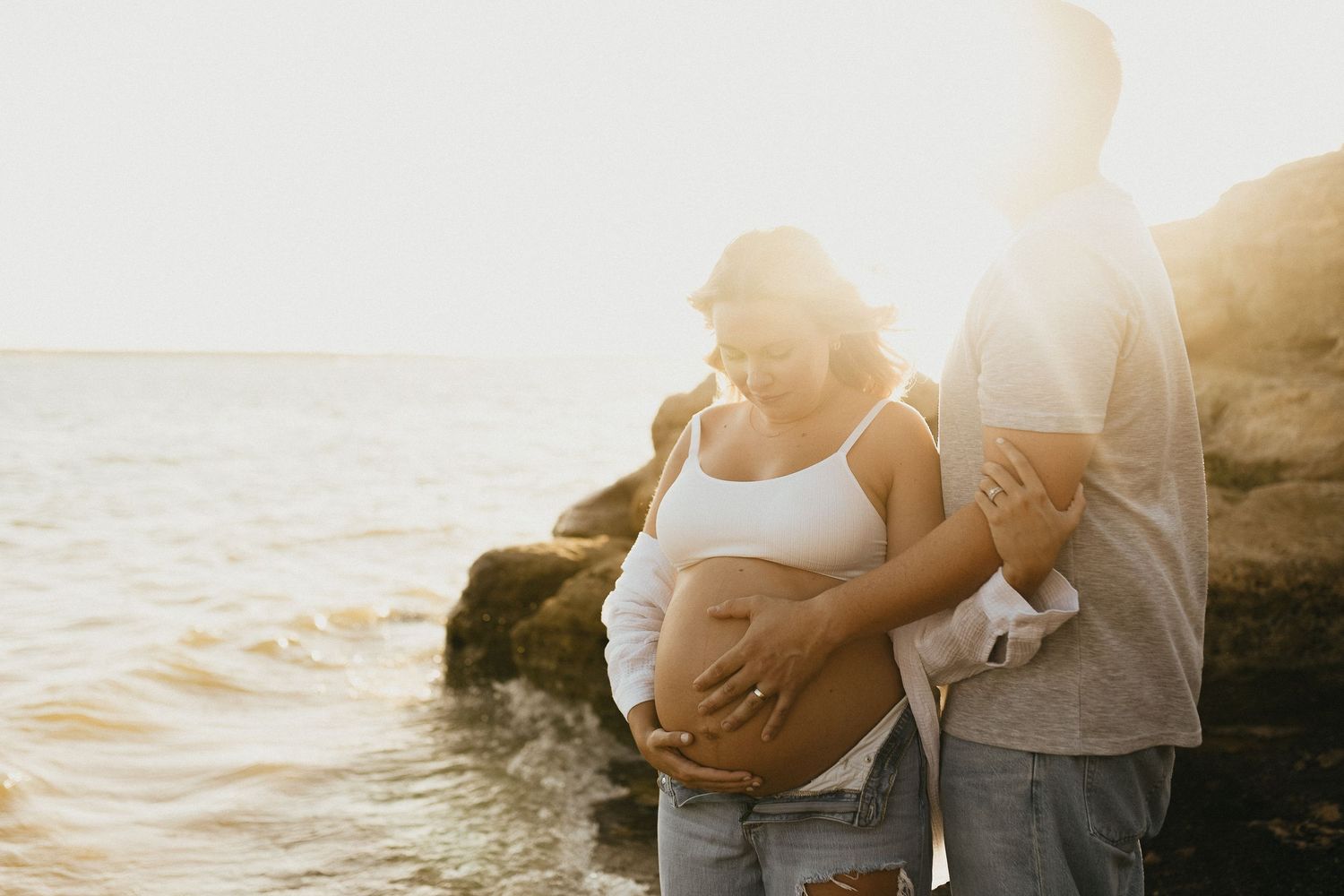 Expecting mother in denim and linen during sunset maternity photos near Flower Mound