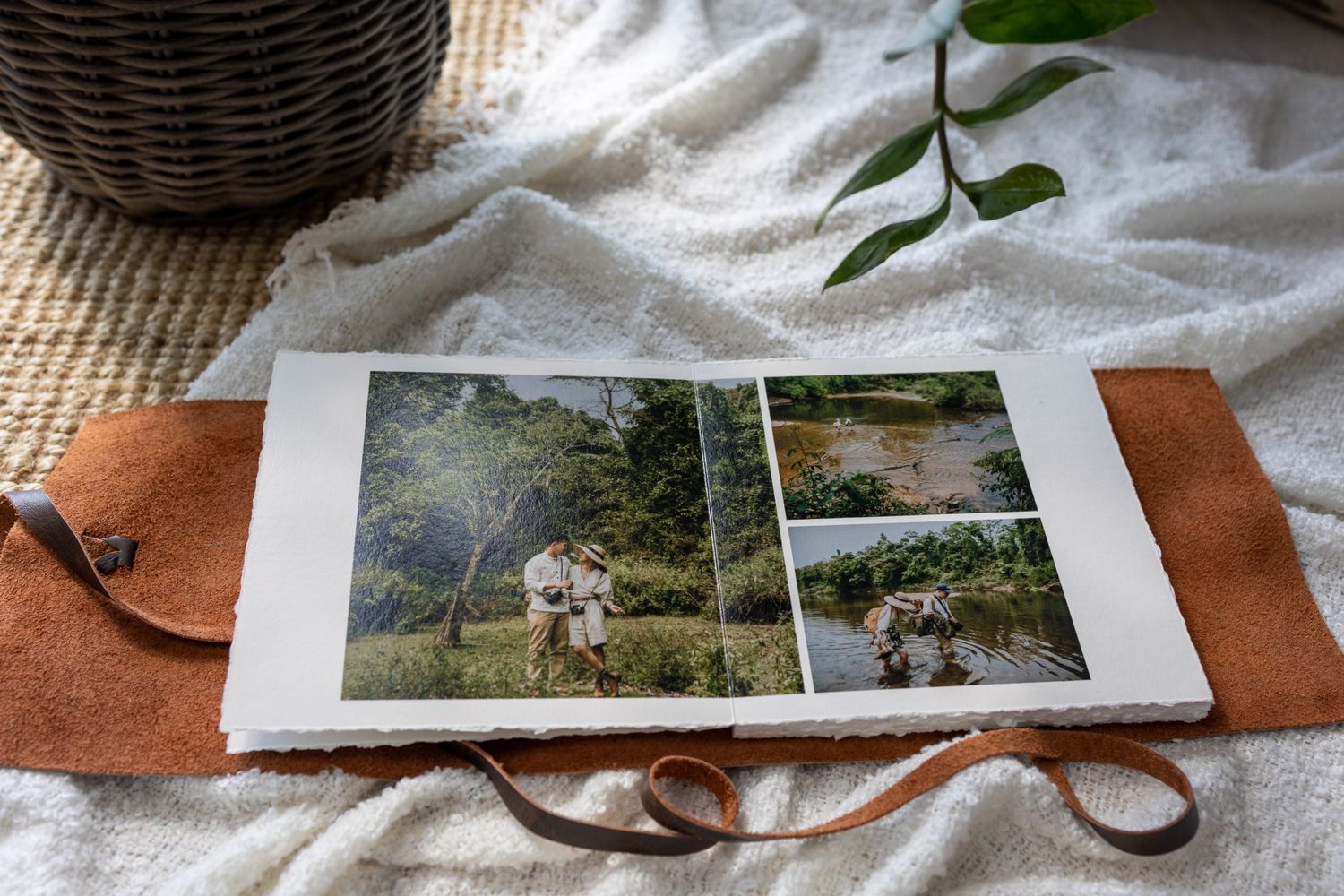 Aufgeschlagenes Fine Art Journal mit Hochzeitsfotos in der Natur und Ledereinband