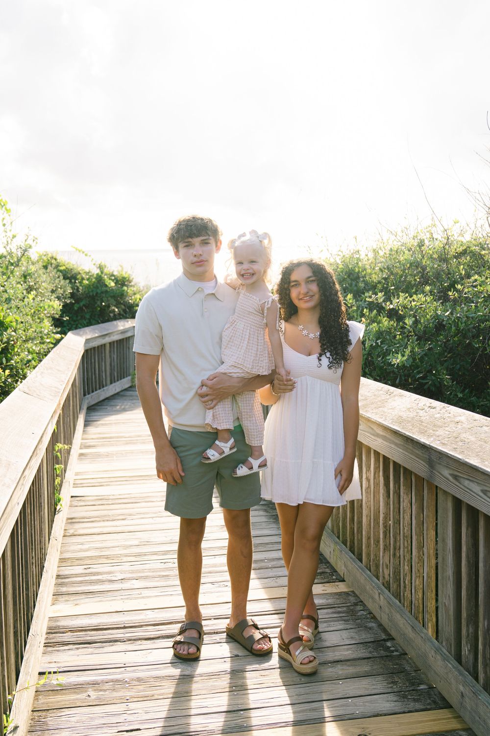 Older siblings with their toddler sister during  south georgia and north florida family beach portrait session
