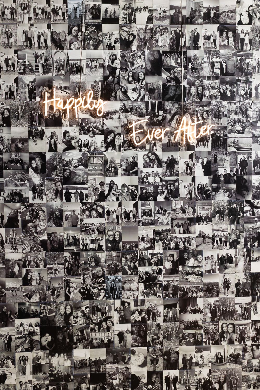 Black-and-white photo collage wall of couple and friends with a glowing neon Happily Ever After sign at a wedding.