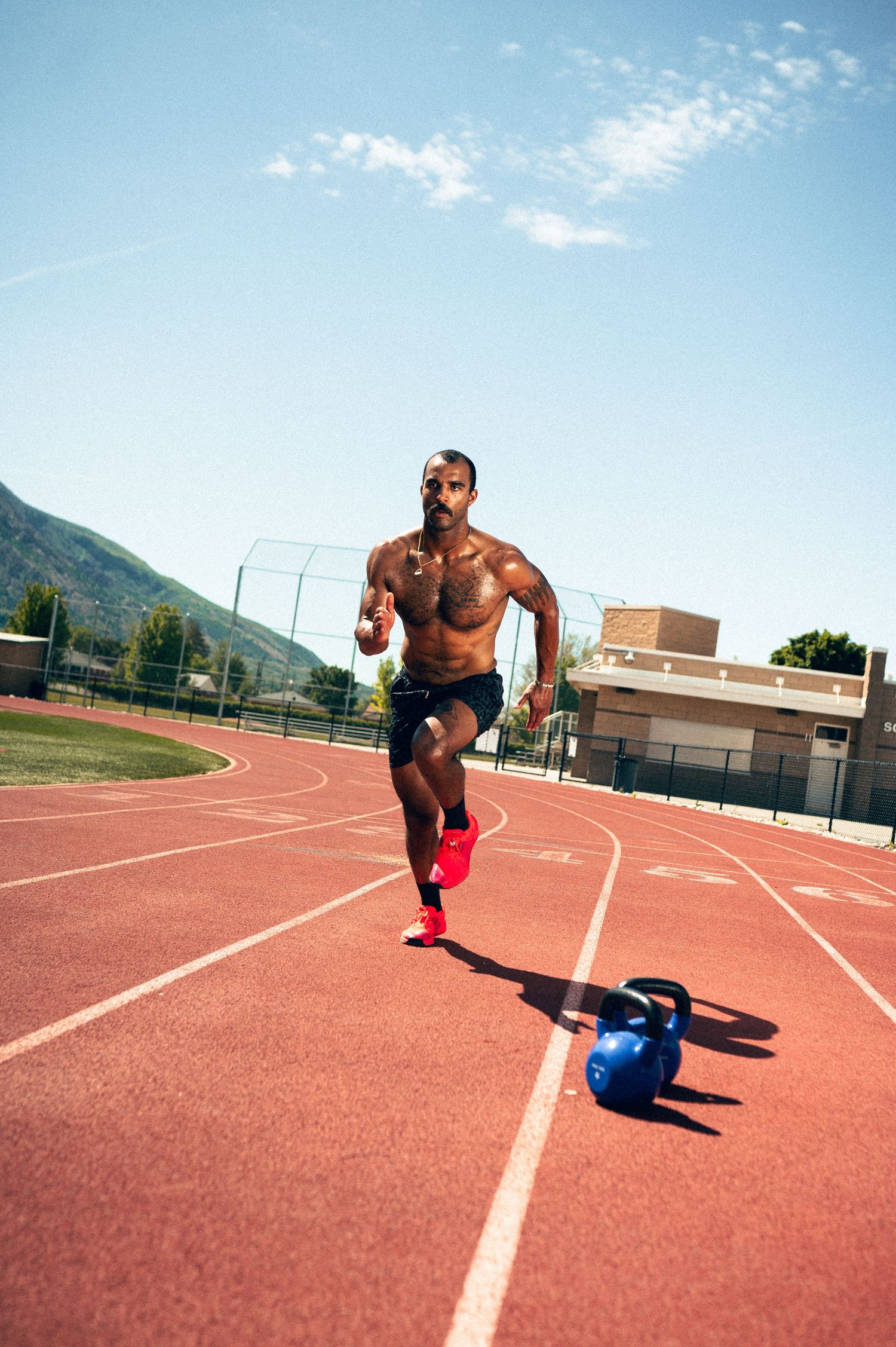 Utah Fitness Photography by Carl James in Salt Lake City. Personal trainer running on a track shirtless, male fitness photography