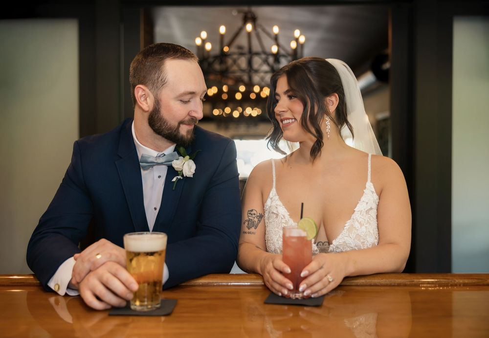 Bride and groom sharing a drink at the clubhouse bar at their Licking Springs Country Club wedding in Newark, Ohio