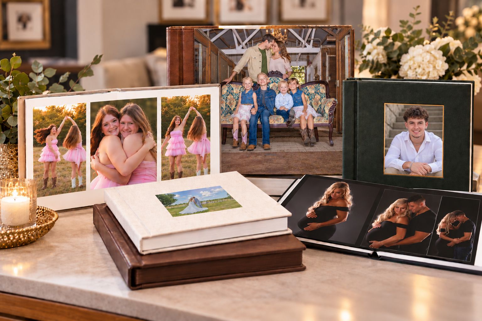 Elegant photo books displayed on a marble table featuring family and couple portraits in decorative leather-bound albums.