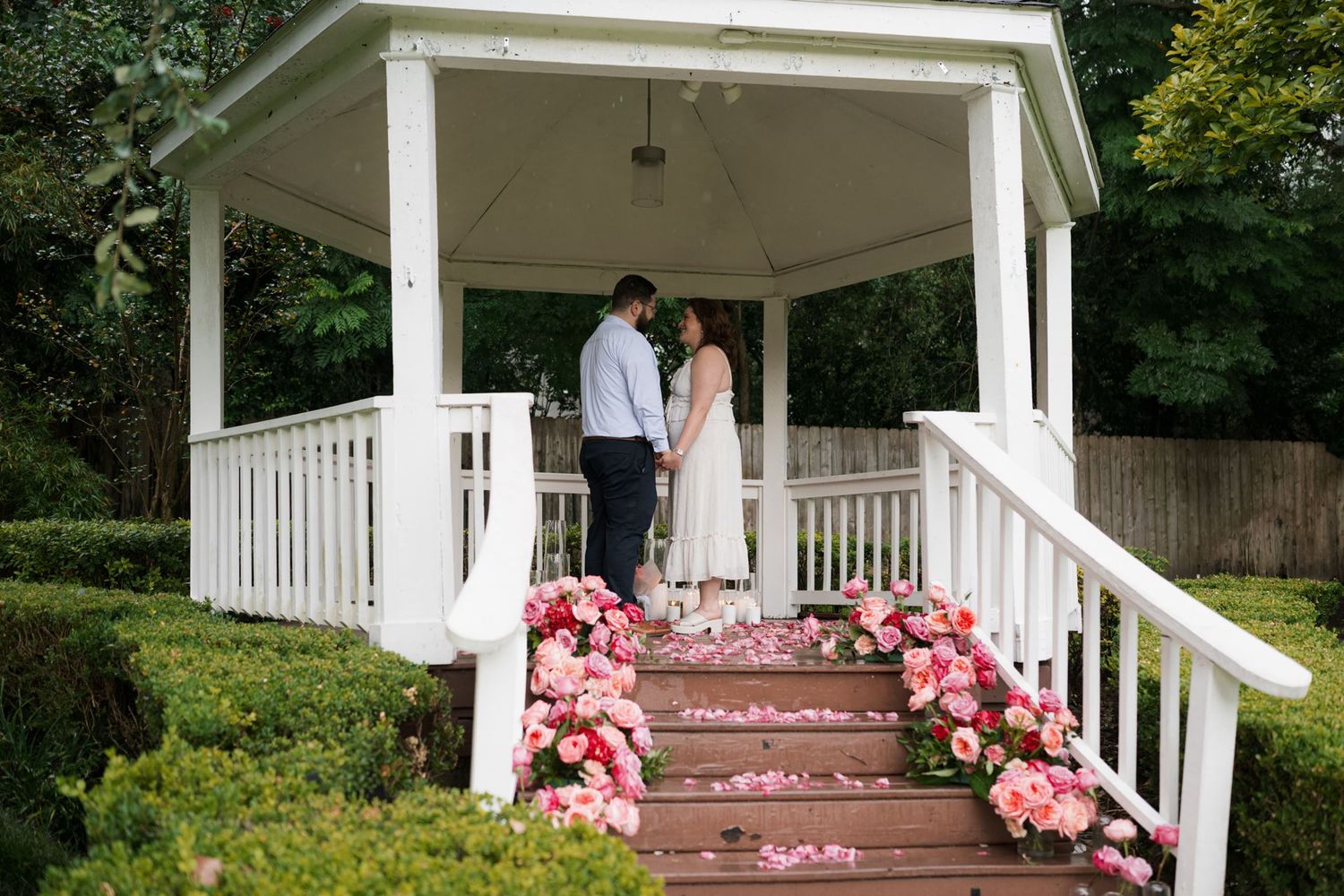 Couple beneath the gazebo moments before their surprise proposal