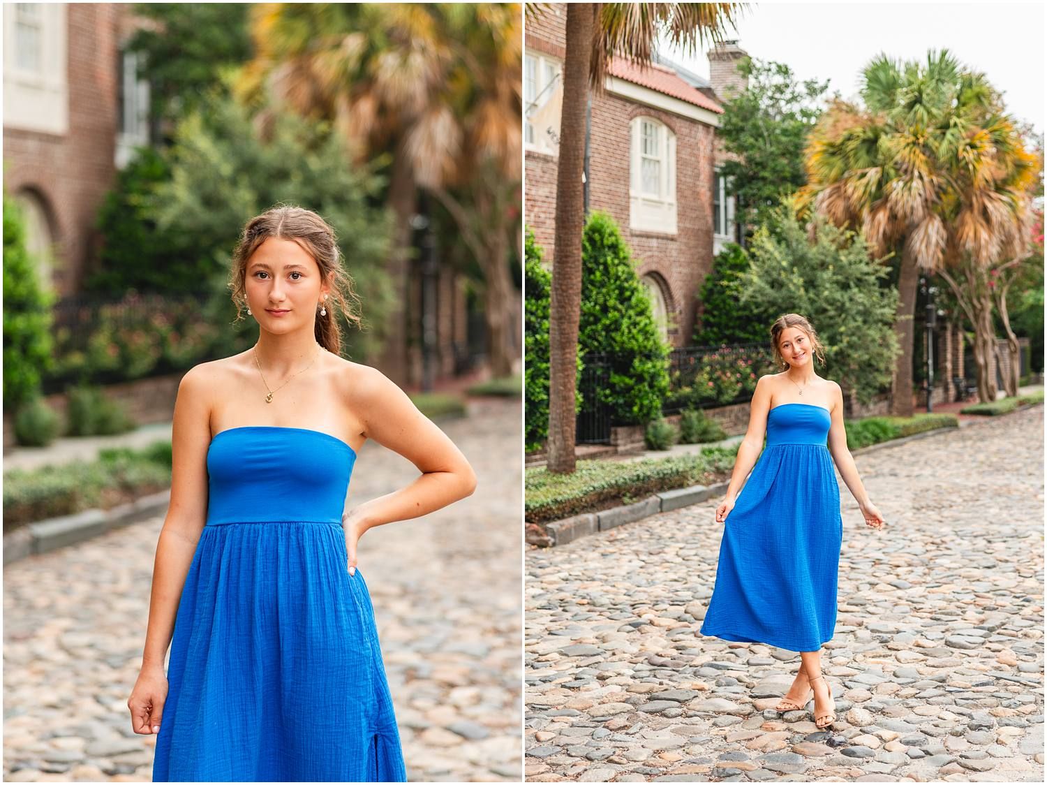 Young woman in a blue strapless midi dress poses on a cobblestone street with brick buildings and palm trees.