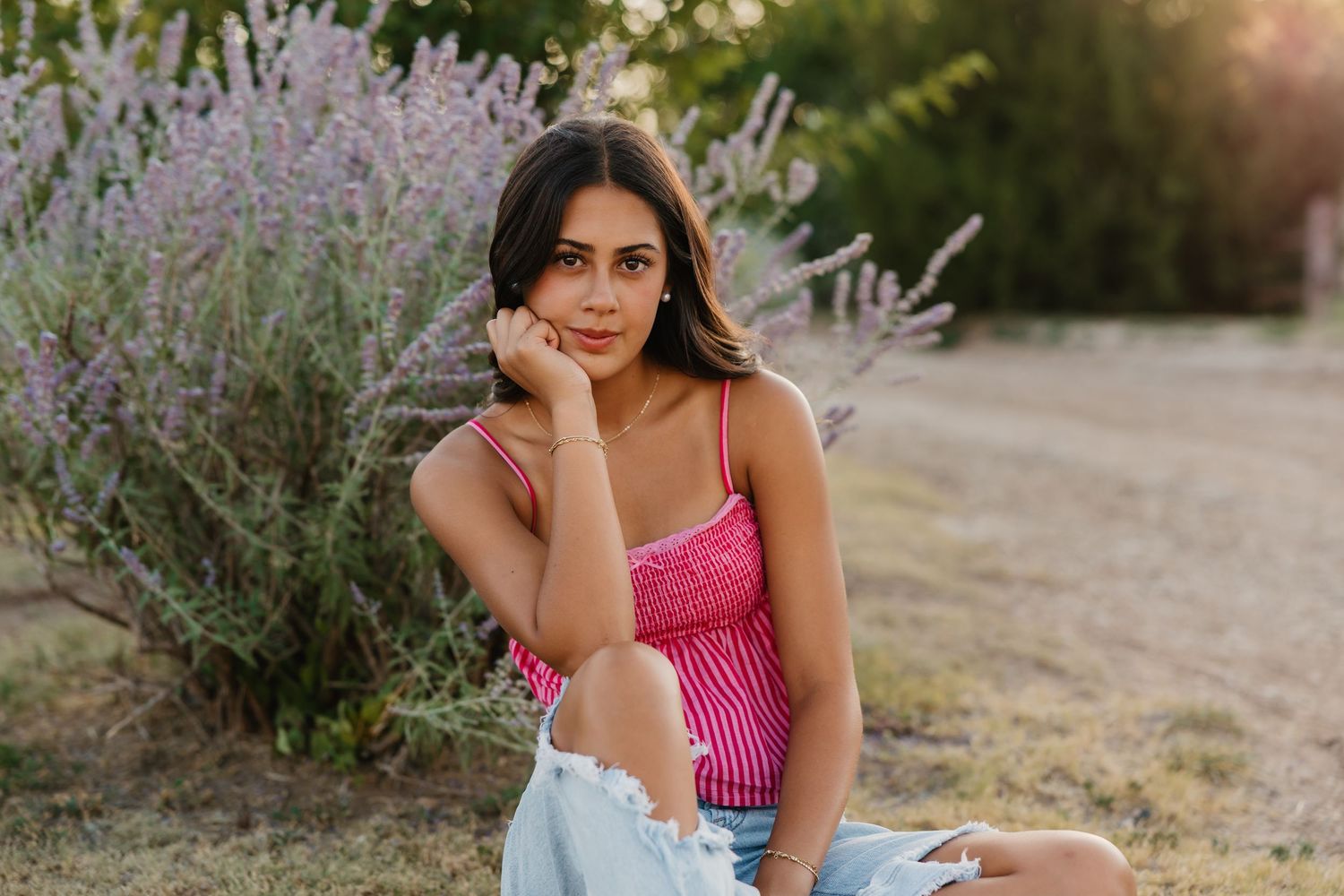 Gorgeous senior photo with girl posing in front of purple sage bush in Tulia Texas