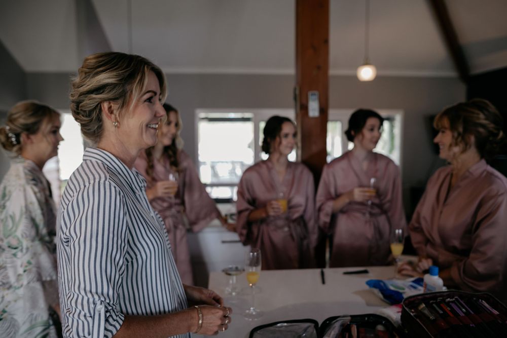 Group gathering in robes and casual wear around a table with drinks.
