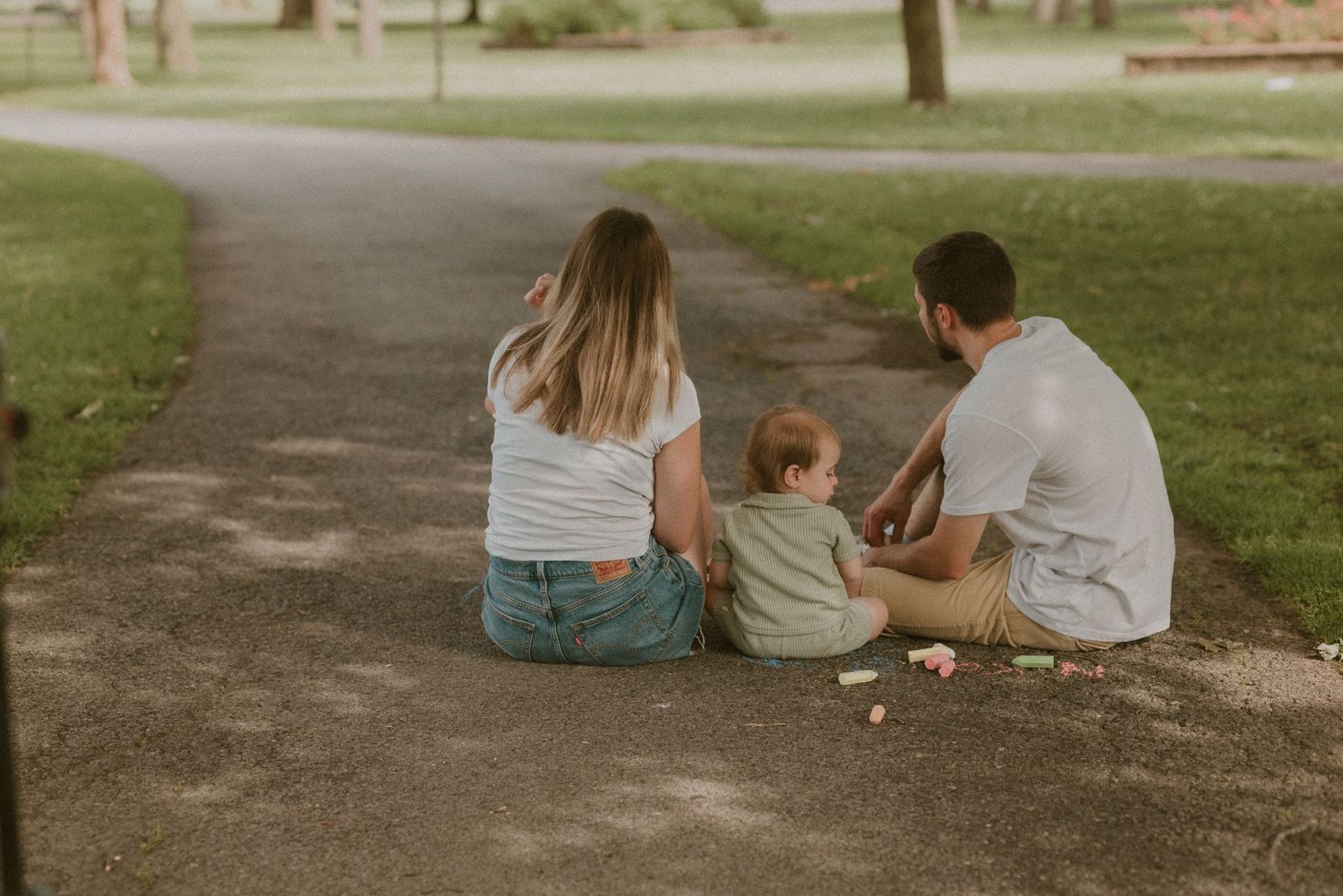 Adult holding a young child's hand outdoors, symbolizing parental guidance and love in a natural setting.