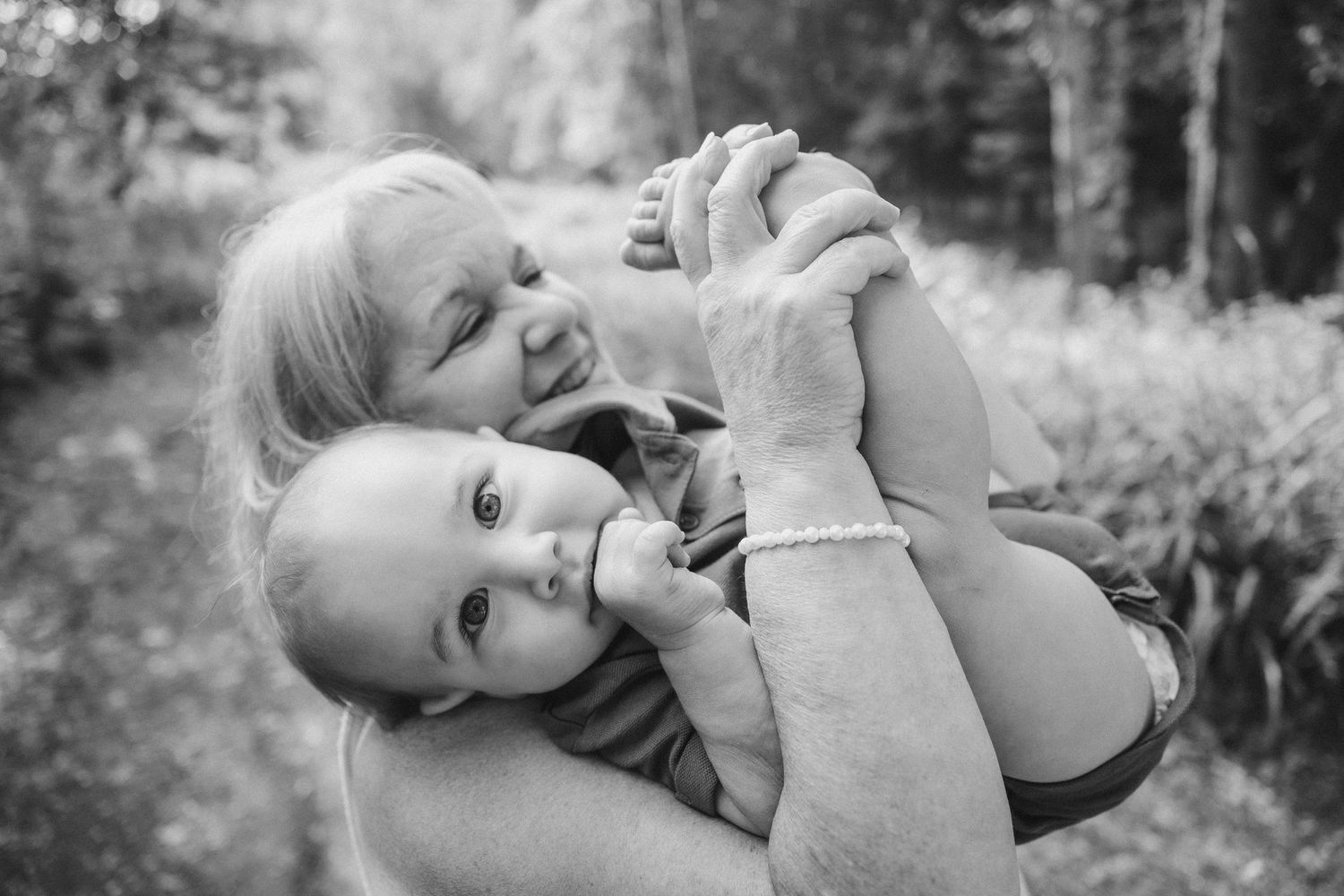 A heartwarming black and white outdoor family embrace.